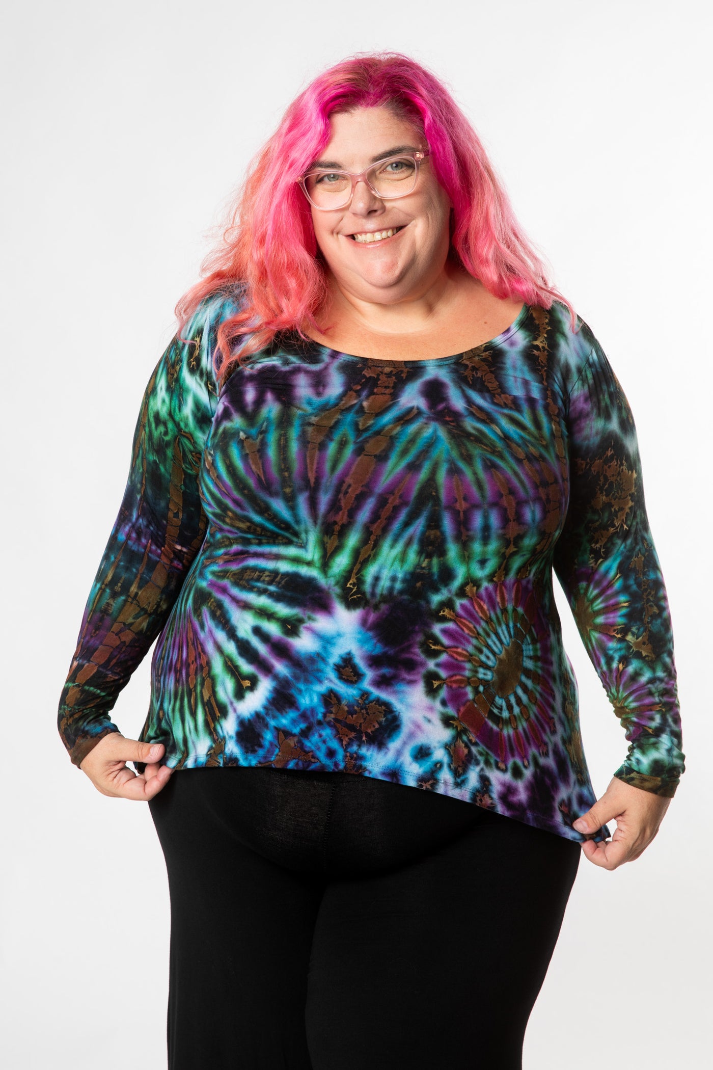 Angel is wearing long sleeve tie dye top in ocean