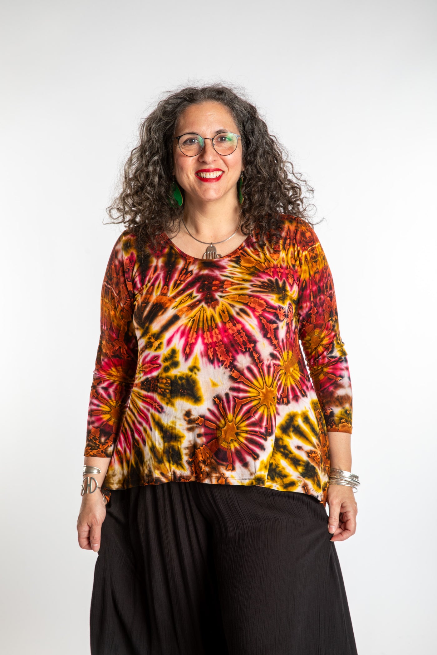 Susan wearing a orange long sleeve tie dye shirt in Sunset