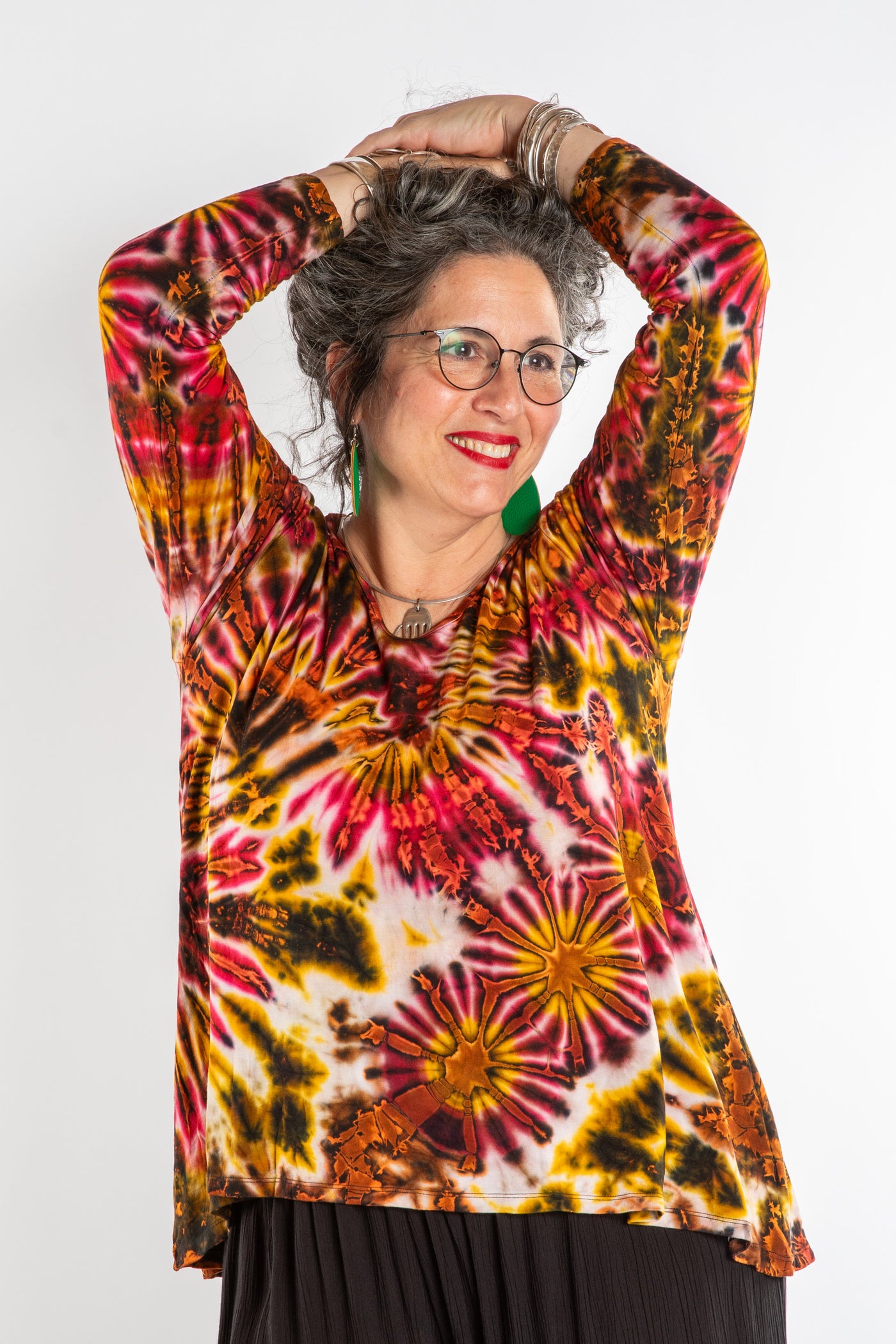 Susan wearing a orange long sleeve tie dye shirt in Sunset