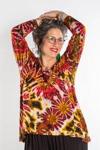 Susan wearing a orange long sleeve tie dye shirt in Sunset