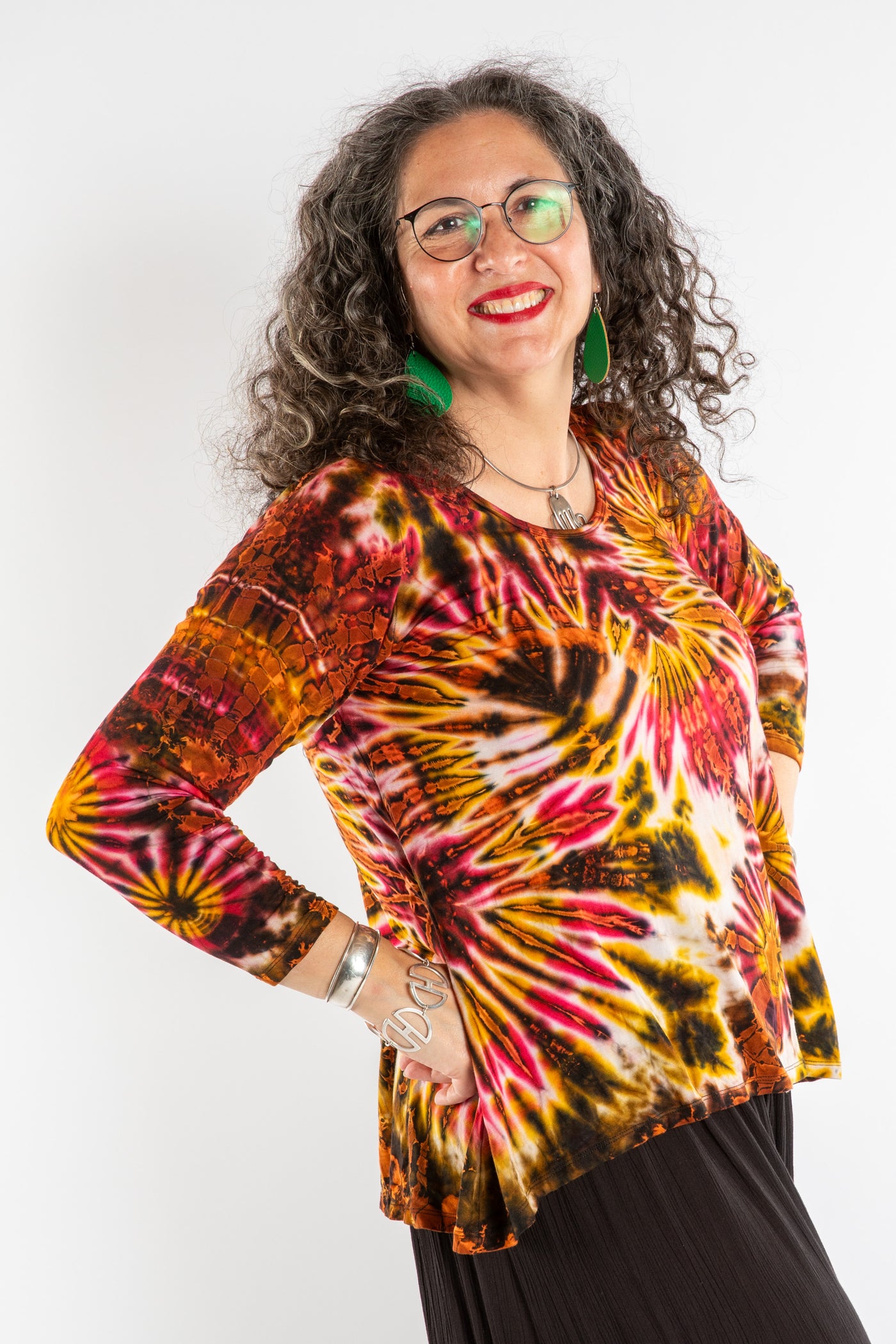 Susan wearing a orange long sleeve tie dye shirt in Sunset