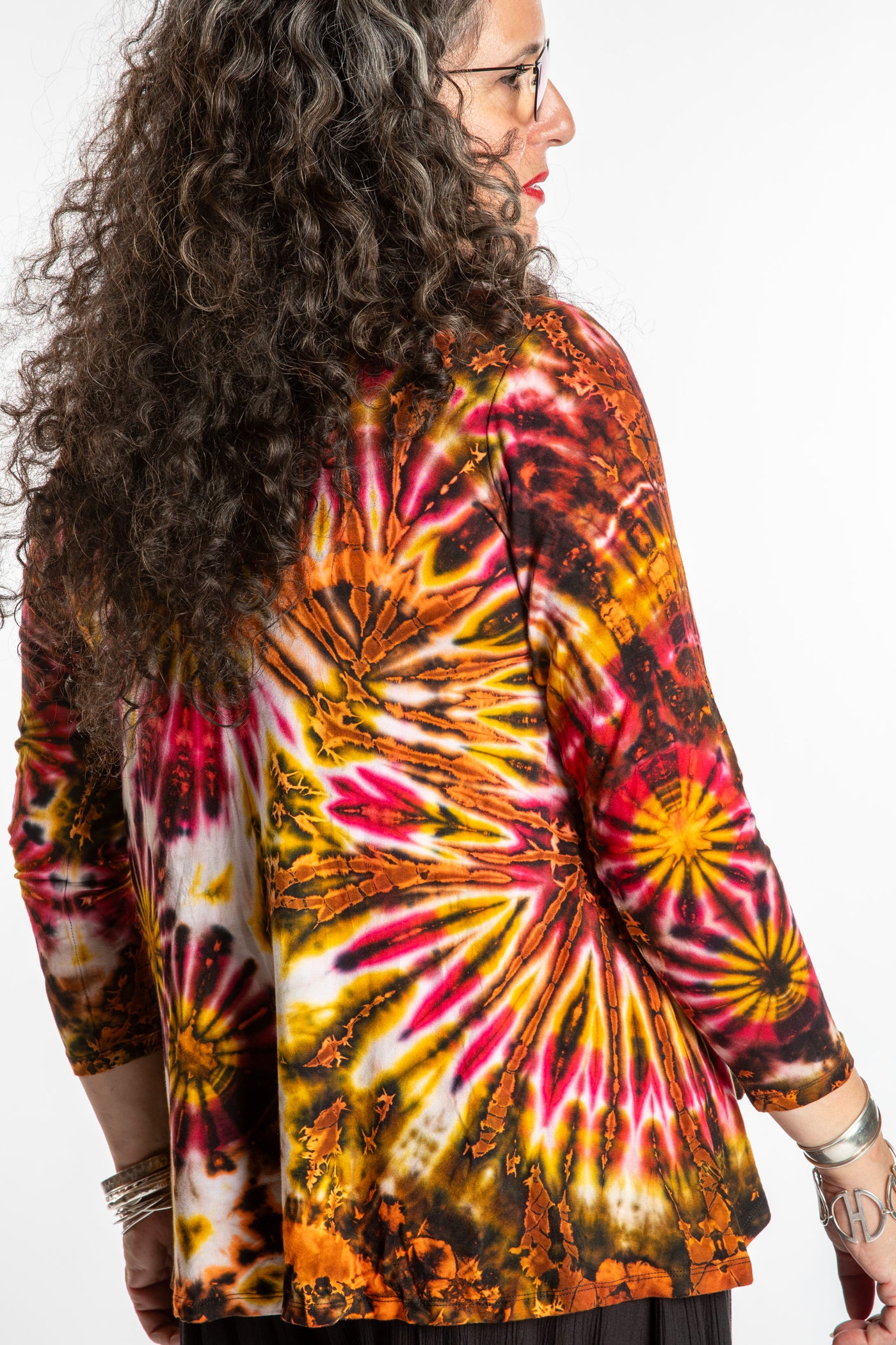 Susan wearing a orange long sleeve tie dye shirt in Sunset