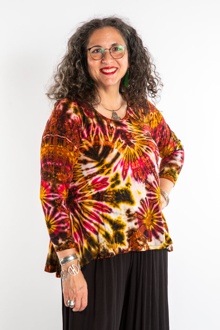 Susan wearing a orange long sleeve tie dye shirt in Sunset
