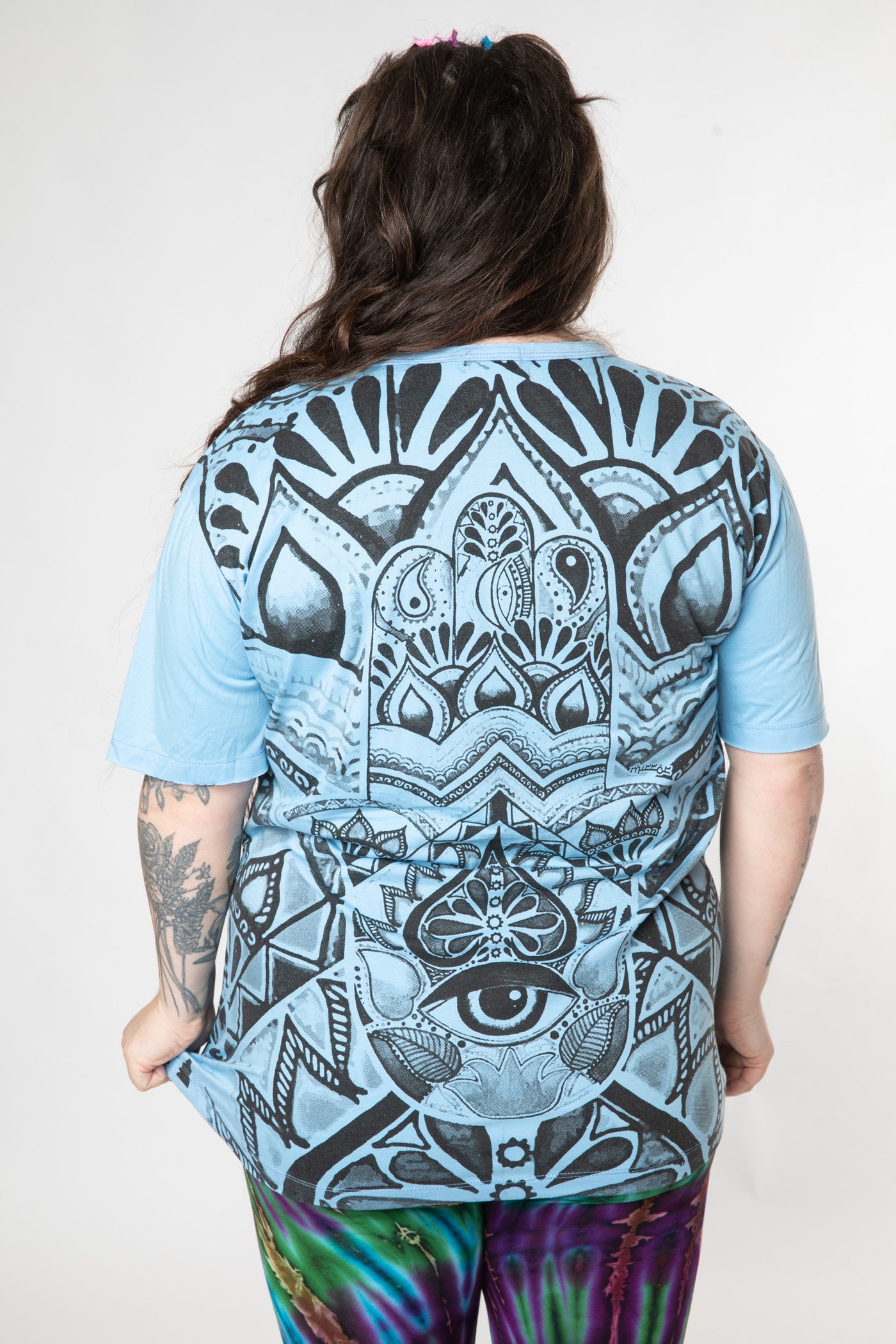 Desiree is wearing size L light blue hamsa t shirt 