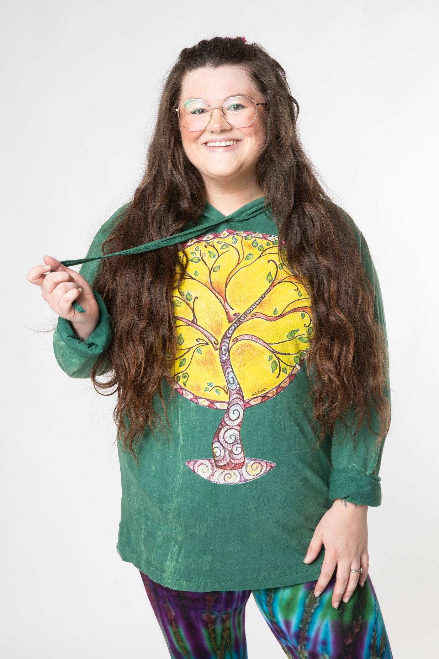 Desiree is wearing size L green tree lightweight hoodie