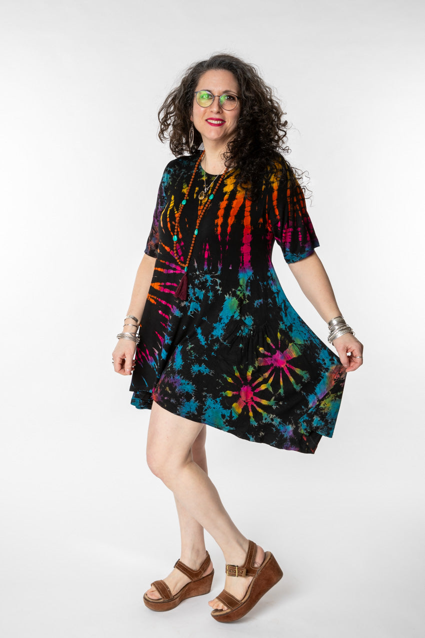 Susan is wearing a tie dye dress in black rainbow
