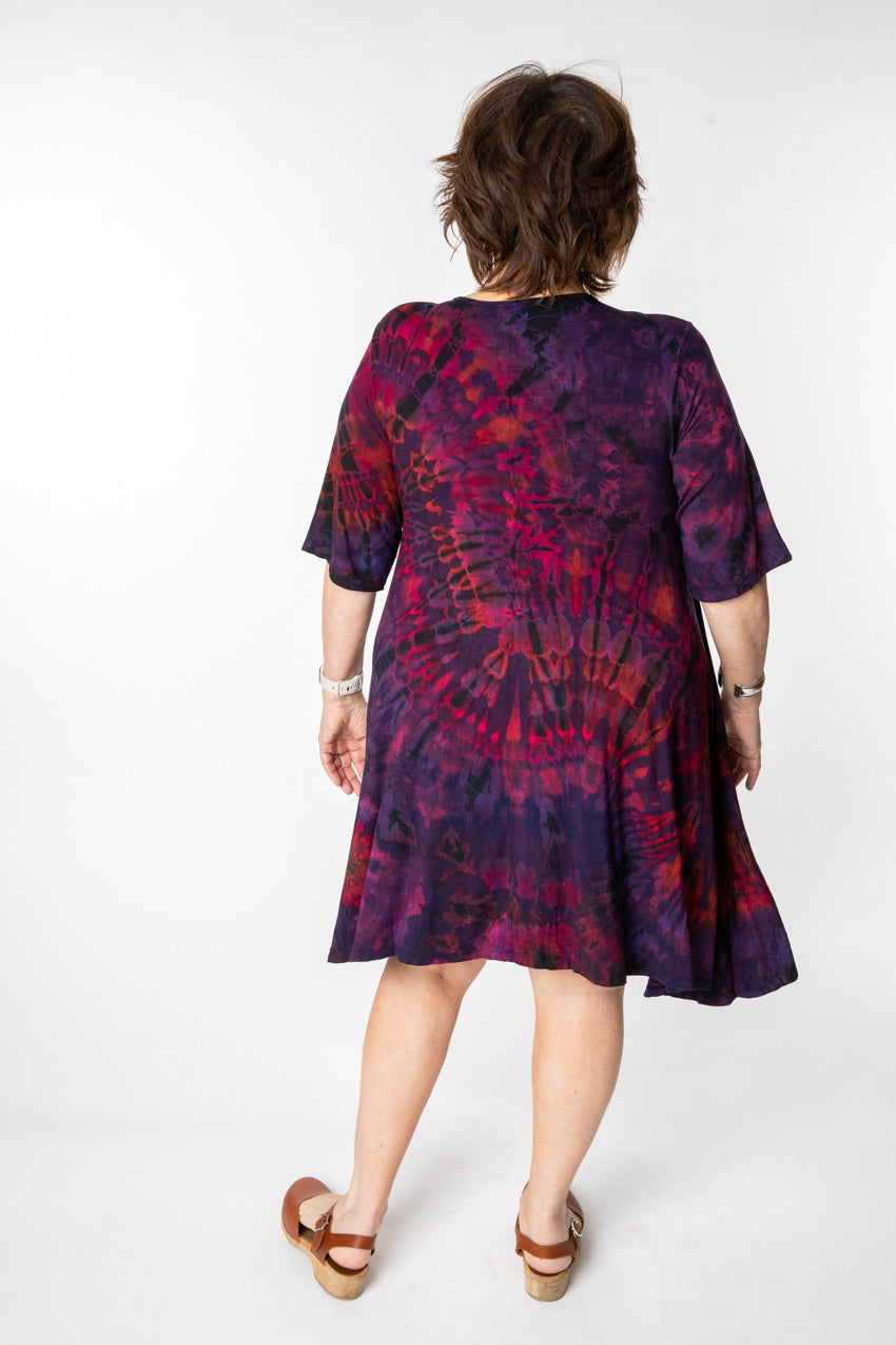 Betty is wearing a tie dye dress in eggplant