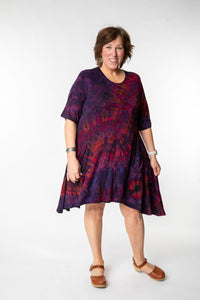 Betty is wearing a tie dye dress in eggplant