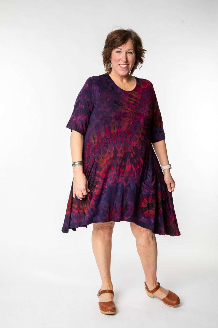 Betty is wearing a tie dye dress in eggplant