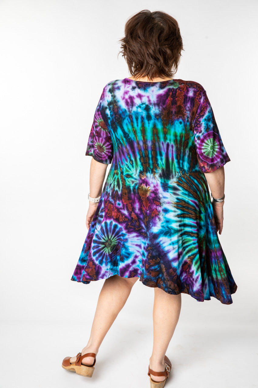 Betty is wearing a tie dye dress in ocean
