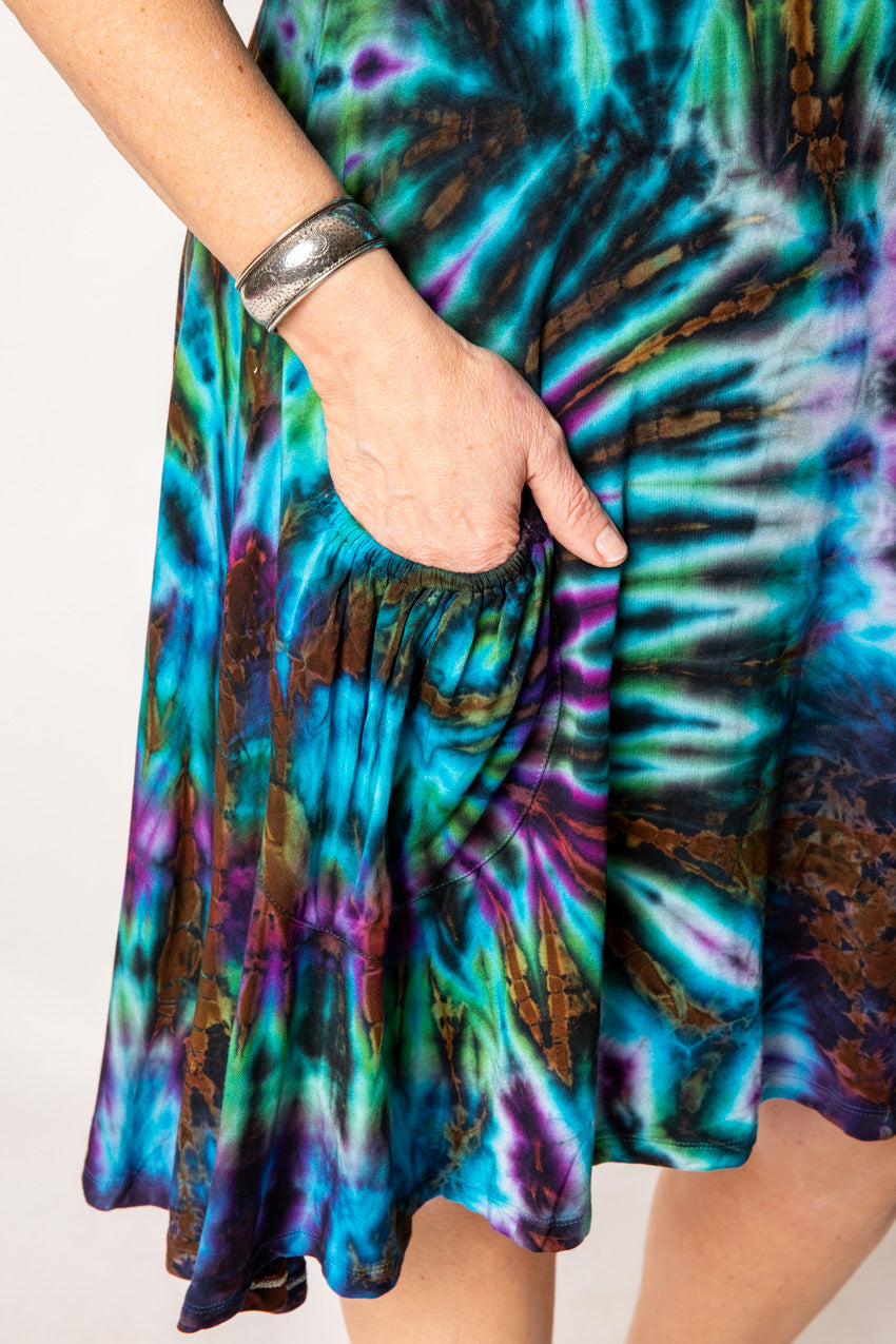 Betty is wearing a tie dye dress in ocean