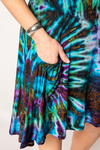 Betty is wearing a tie dye dress in ocean