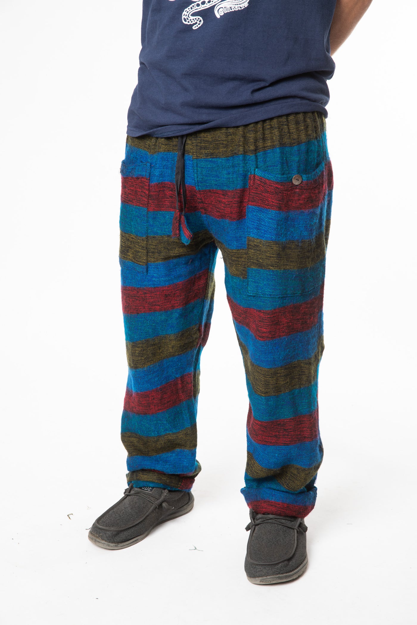 Harvey is wearing size M blanket pants in multicolor