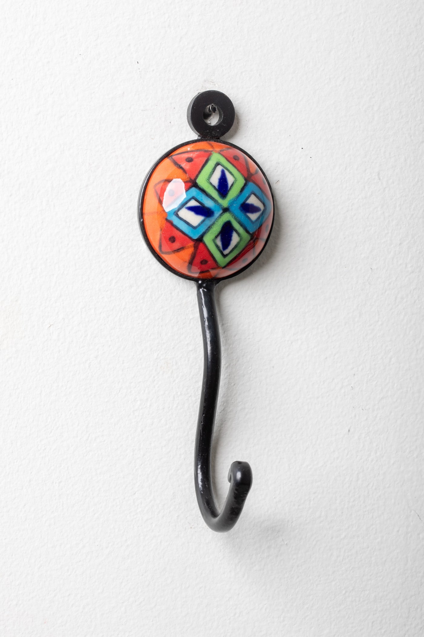 Round ceramic tile hook in orange geo
