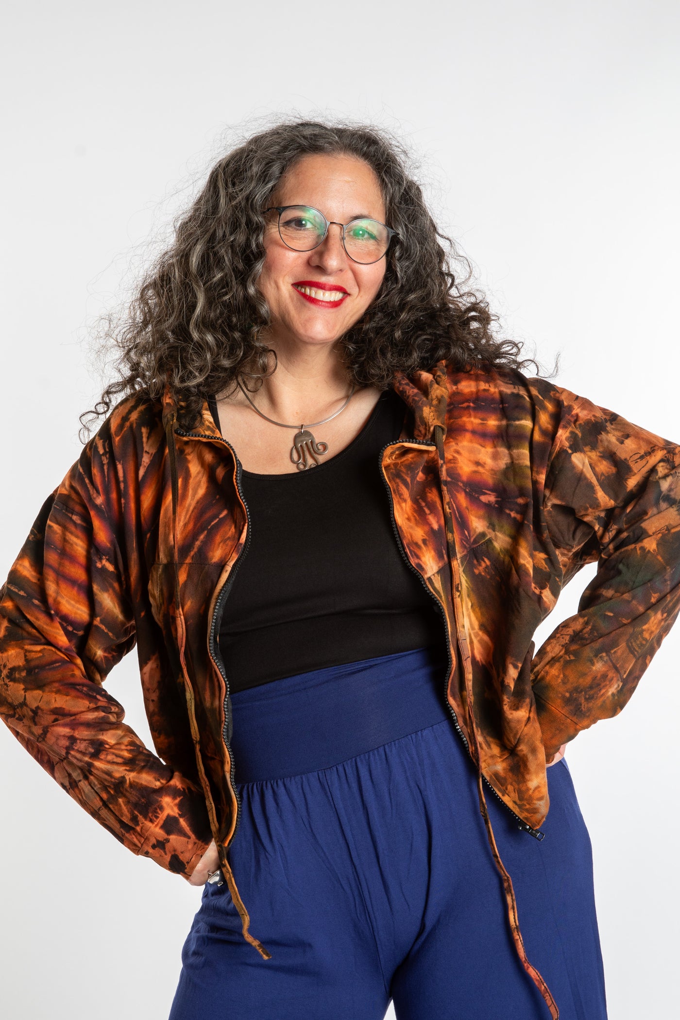 Susan wearing a M/L orange tie dye cropped hoodie in Sunset