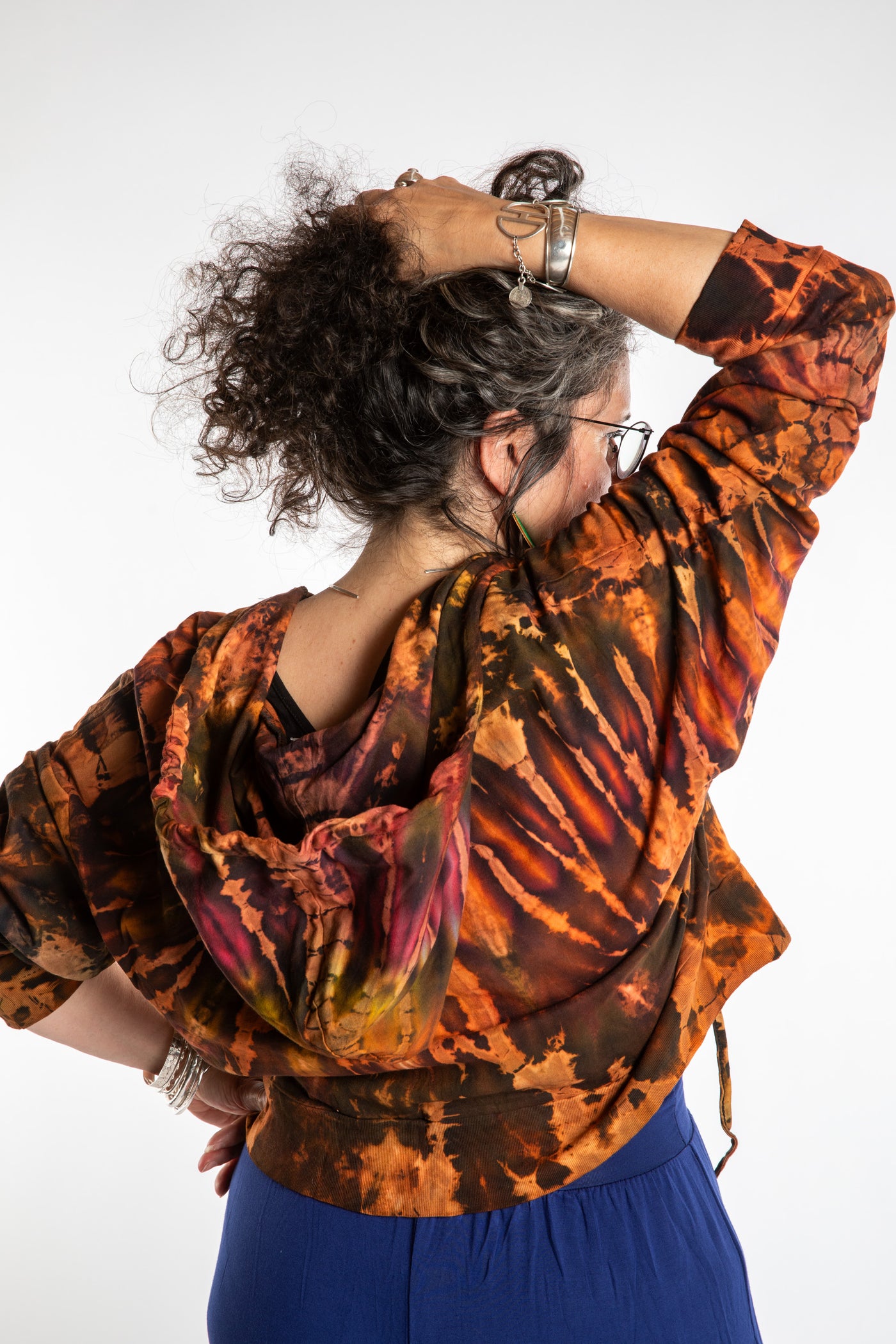Susan wearing a M/L orange tie dye cropped hoodie in Sunset