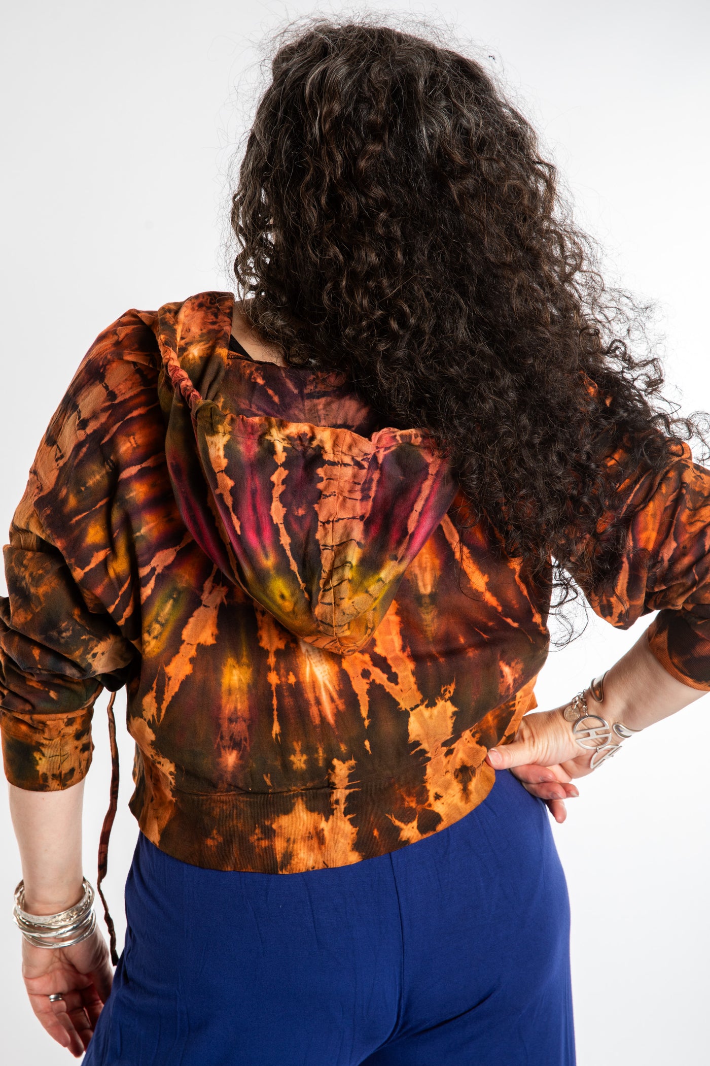 Susan wearing a M/L orange tie dye cropped hoodie in Sunset