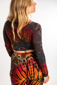 Sophie is wearing a S/M orange tie dye crop top in Brown