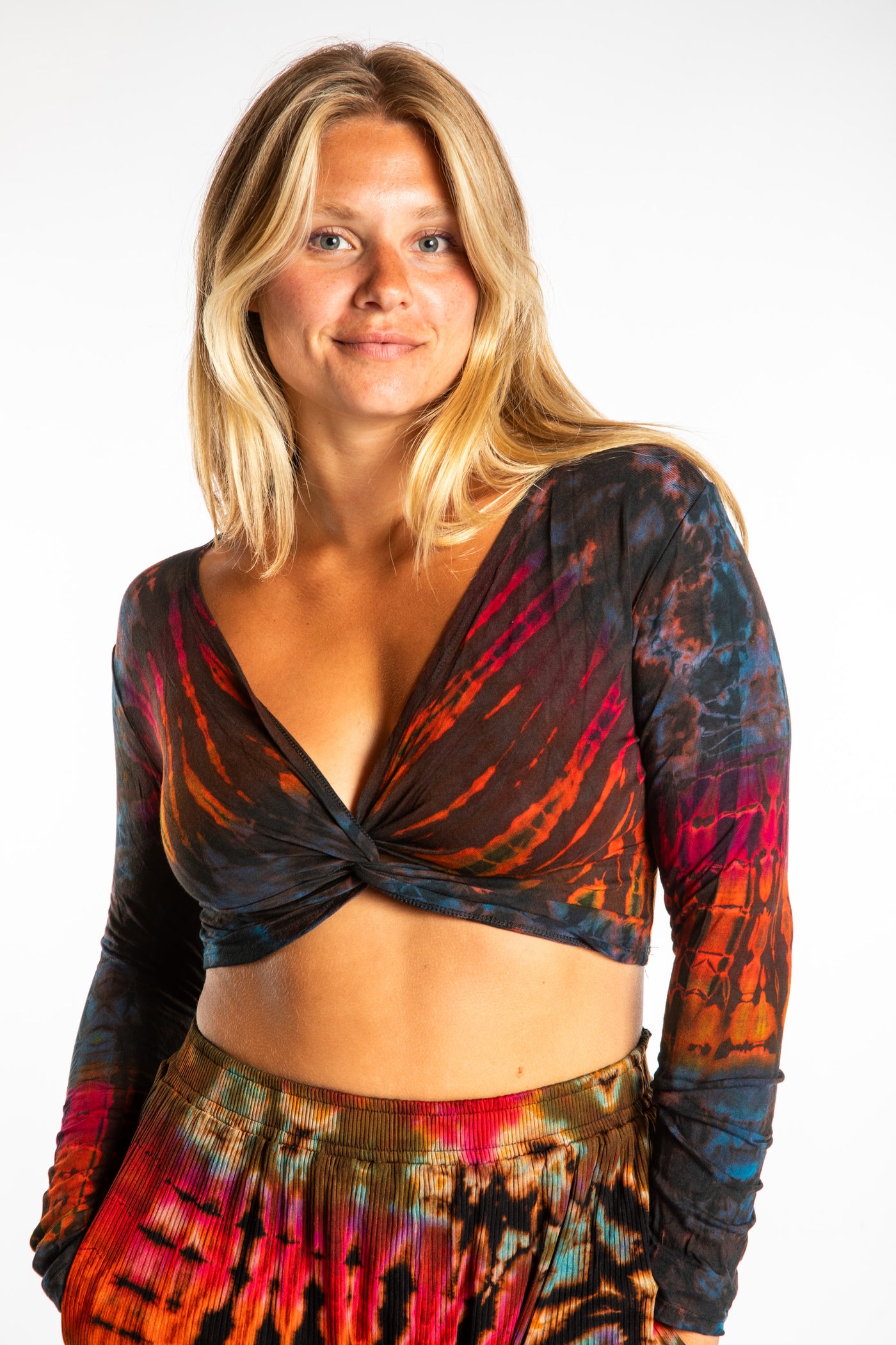 Sophie is wearing a S/M orange tie dye crop top in Brown