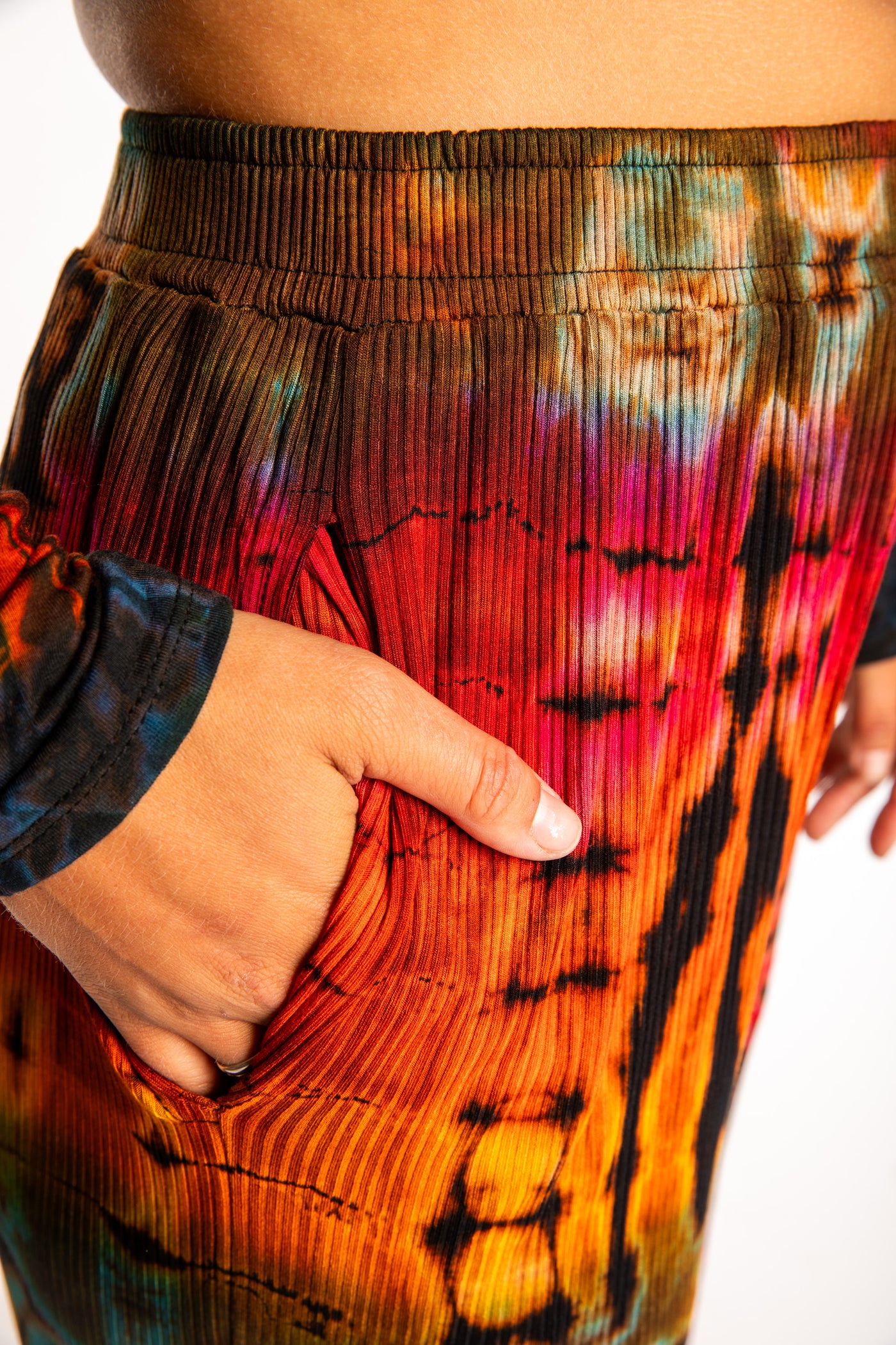 Sophie wearing orange tie dye pants in Black Rainbow