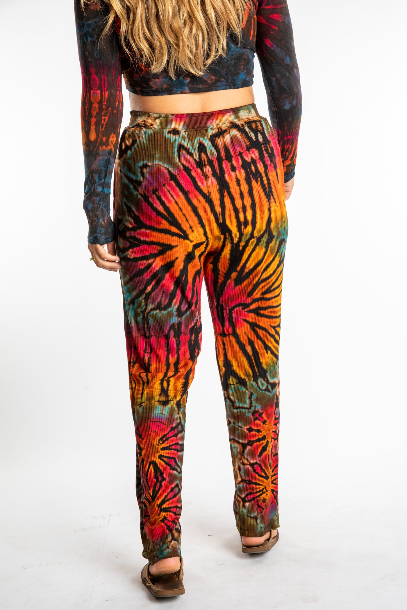 Sophie wearing orange tie dye pants in Black Rainbow