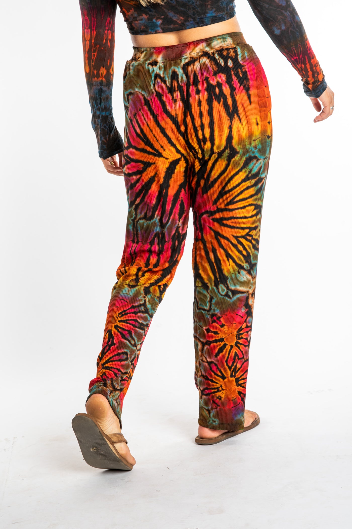 Sophie wearing orange tie dye pants in Black Rainbow