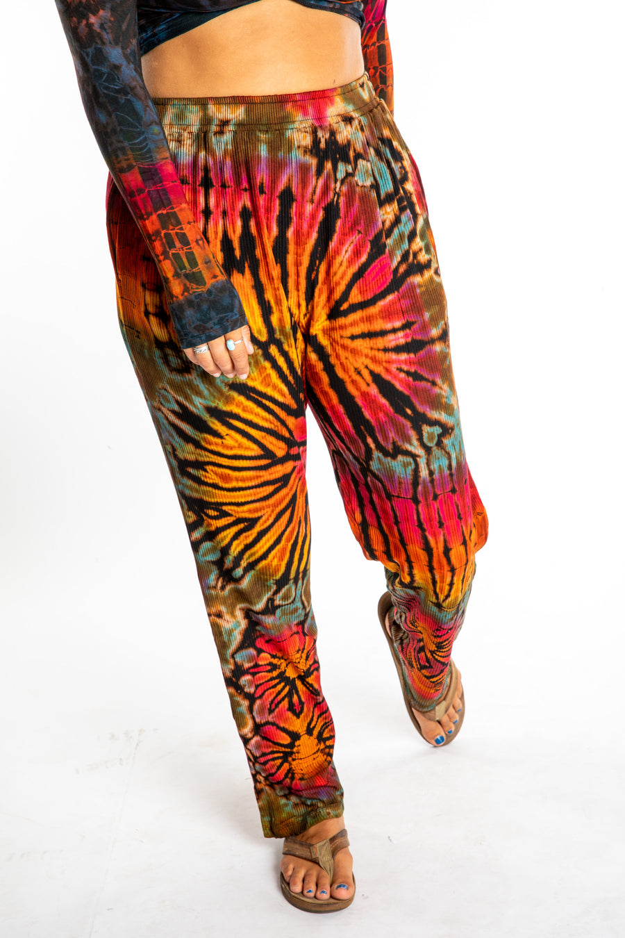 Sophie wearing orange tie dye pants in Black Rainbow