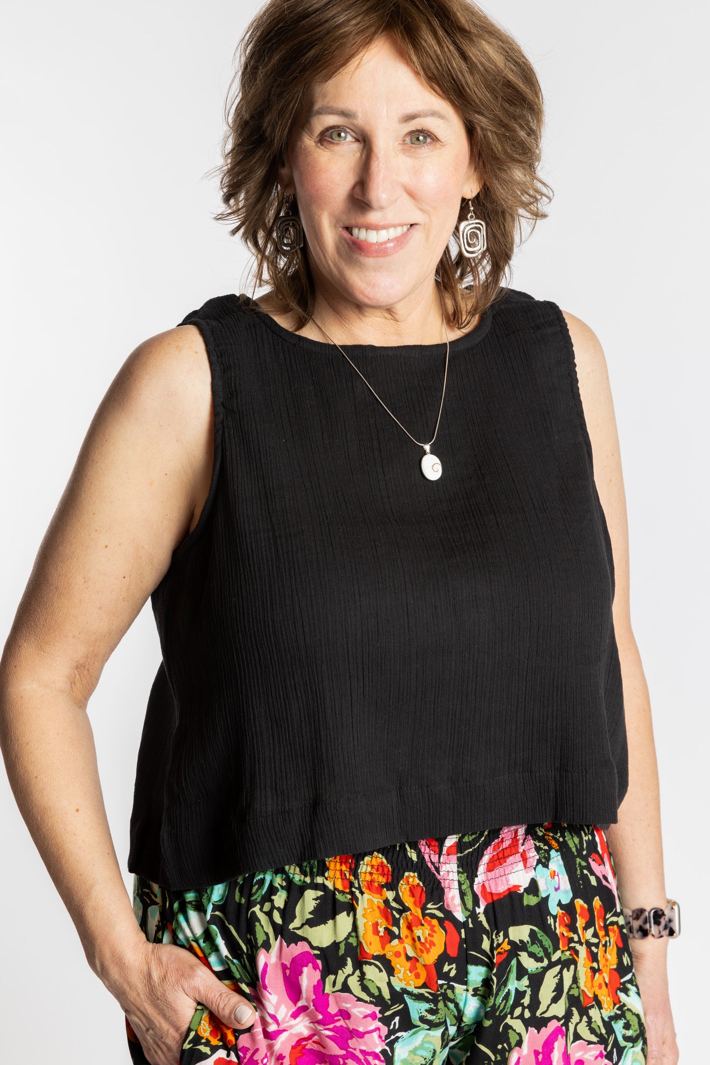 Betty wearing L/XL black sleeveless cotton top with textured fabric and relaxed fit
