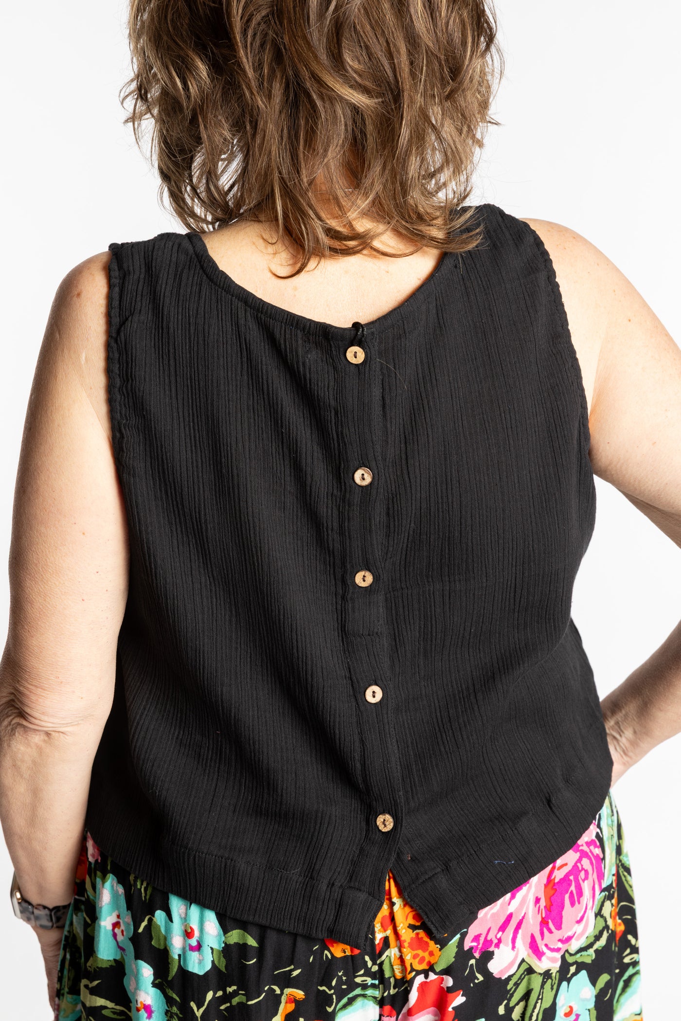 Betty wearing L/XL black sleeveless cotton top with textured fabric and relaxed fit