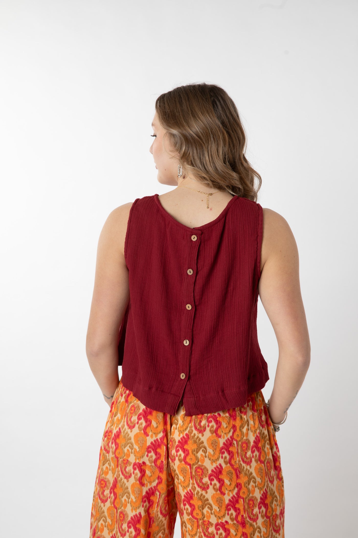 Jacalyn is wearing size S cotton tank top in burgandy