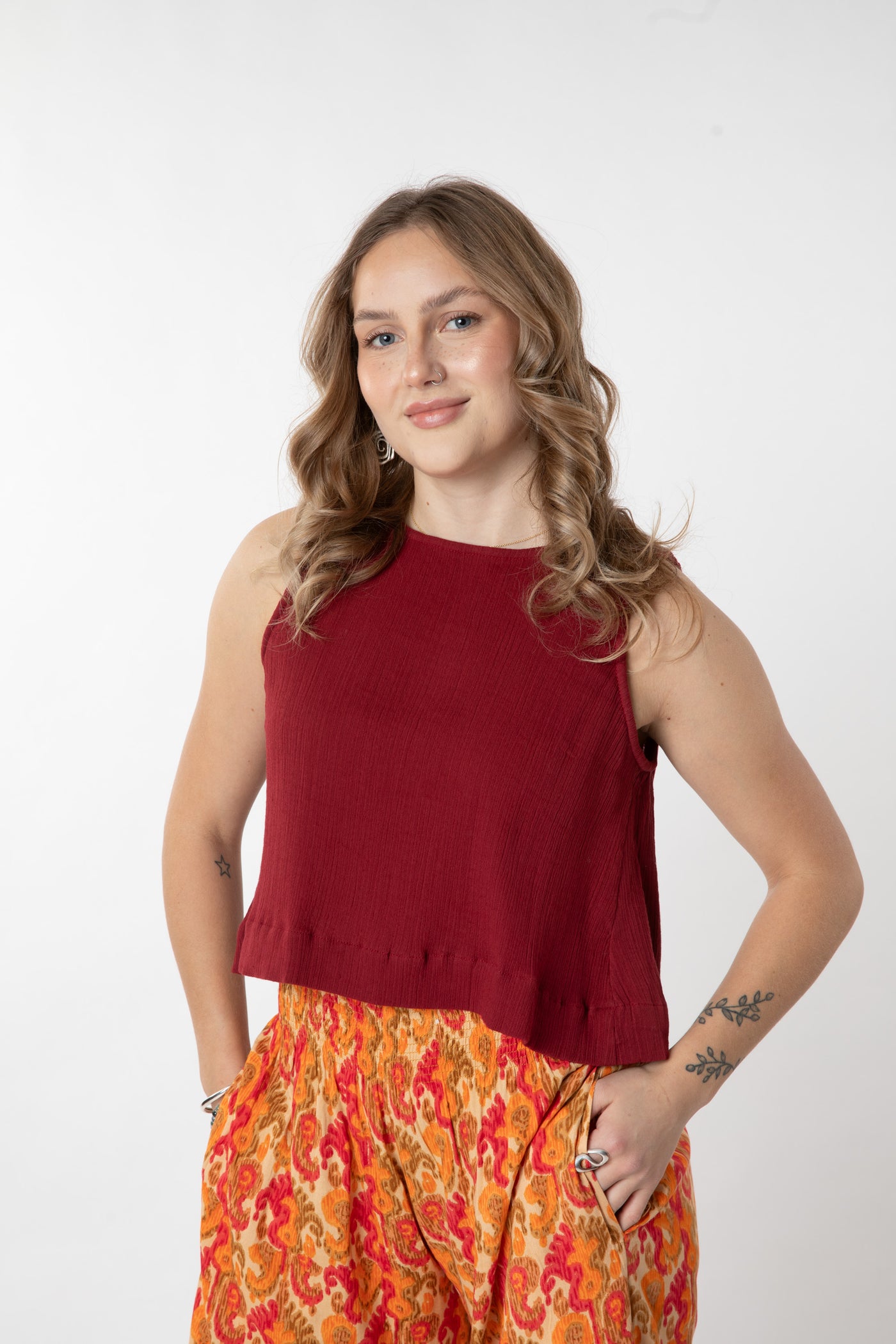 Jacalyn is wearing size S cotton tank top in burgandy
