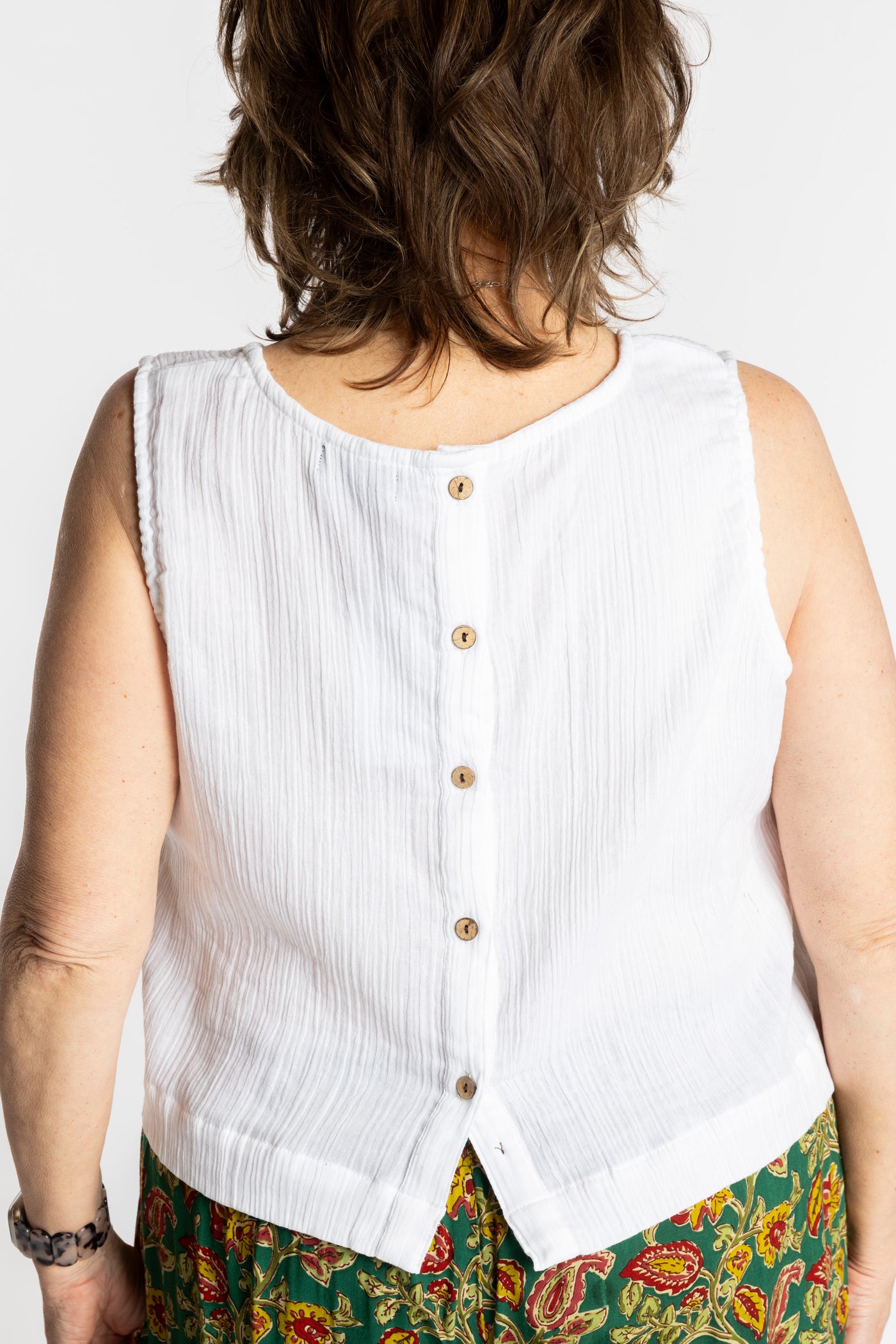 Betty wearing L/XL ivory white sleeveless cotton top with textured fabric and relaxed fit
