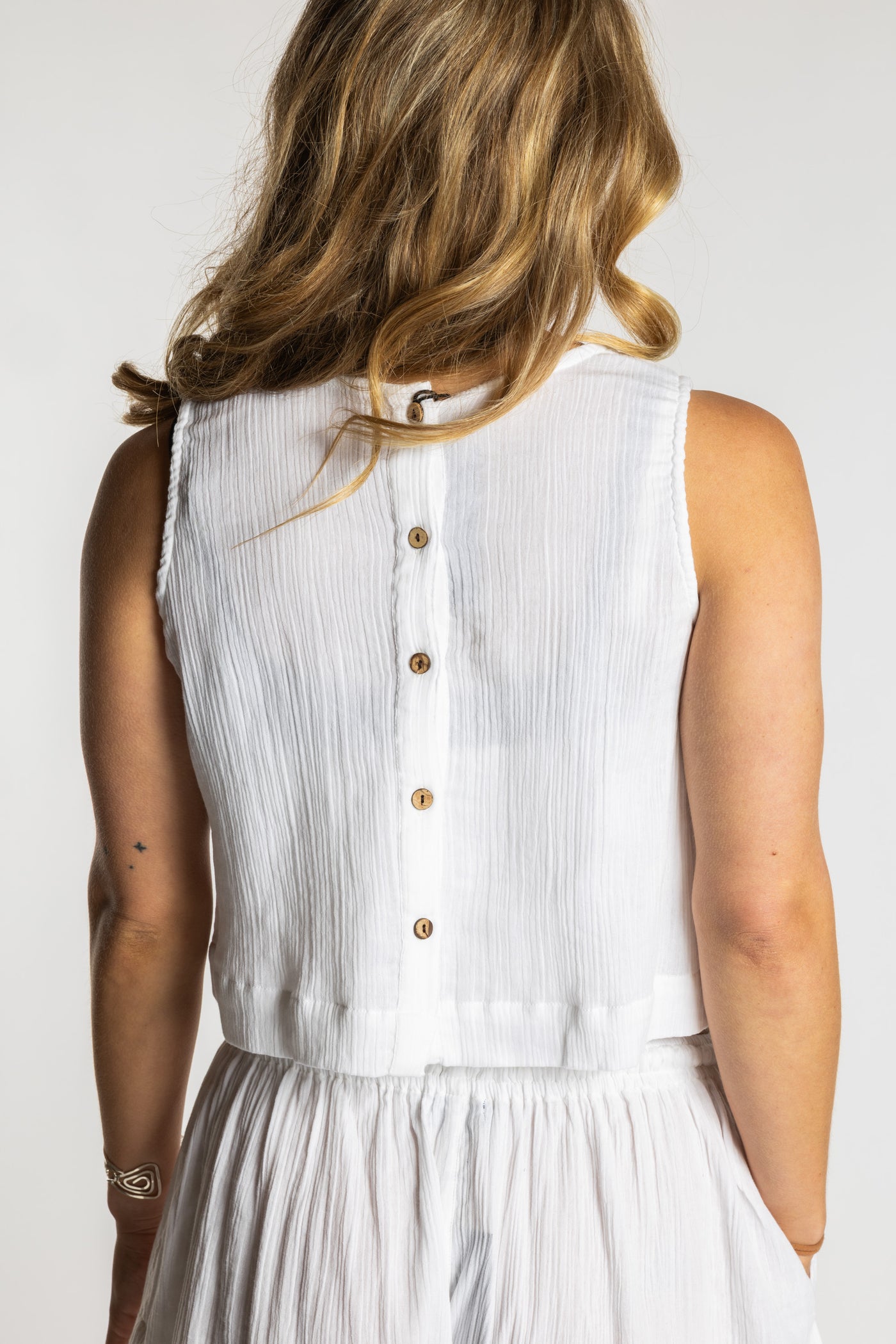 Sophie wearing S/M white ivory sleeveless cotton top with textured fabric and relaxed fit