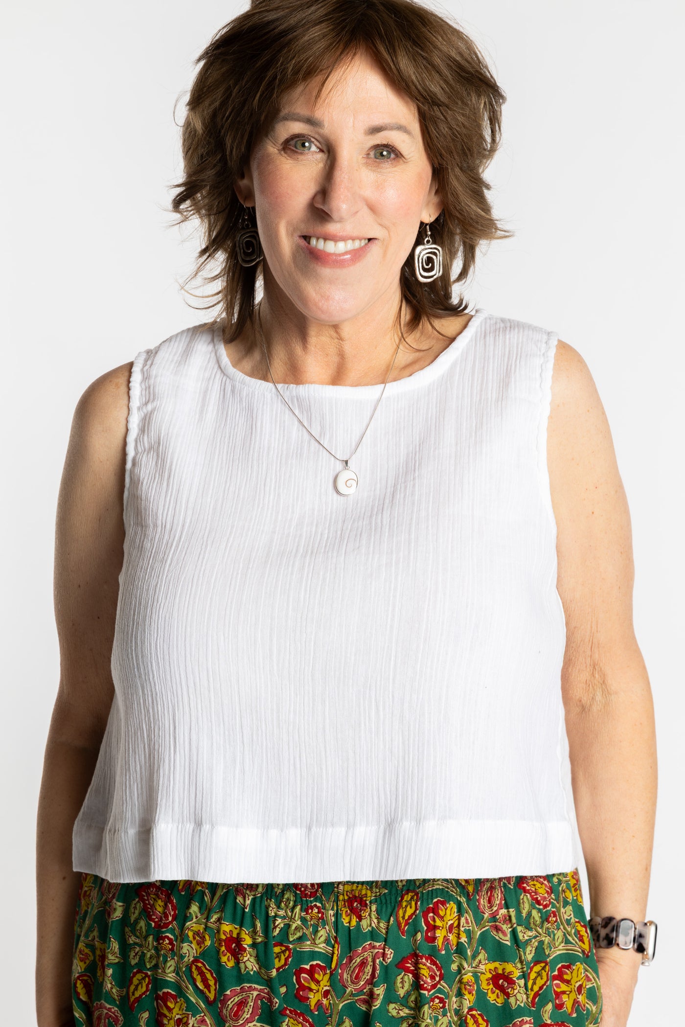 Betty wearing L/XL ivory white sleeveless cotton top with textured fabric and relaxed fit