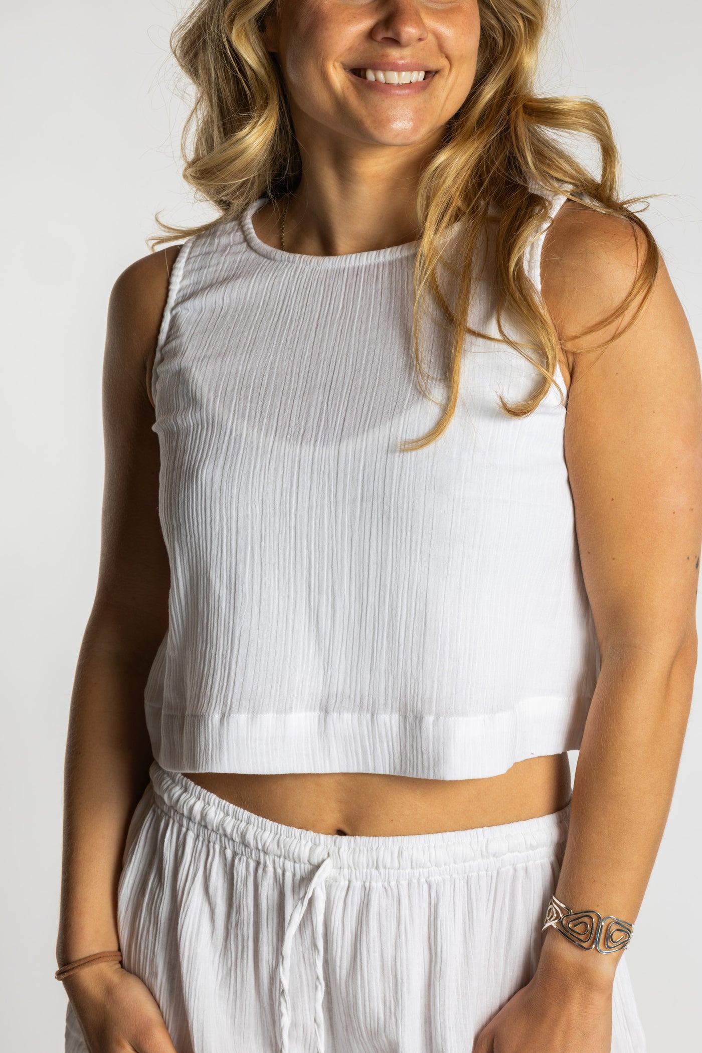 Sophie wearing S/M white ivory sleeveless cotton top with textured fabric and relaxed fit