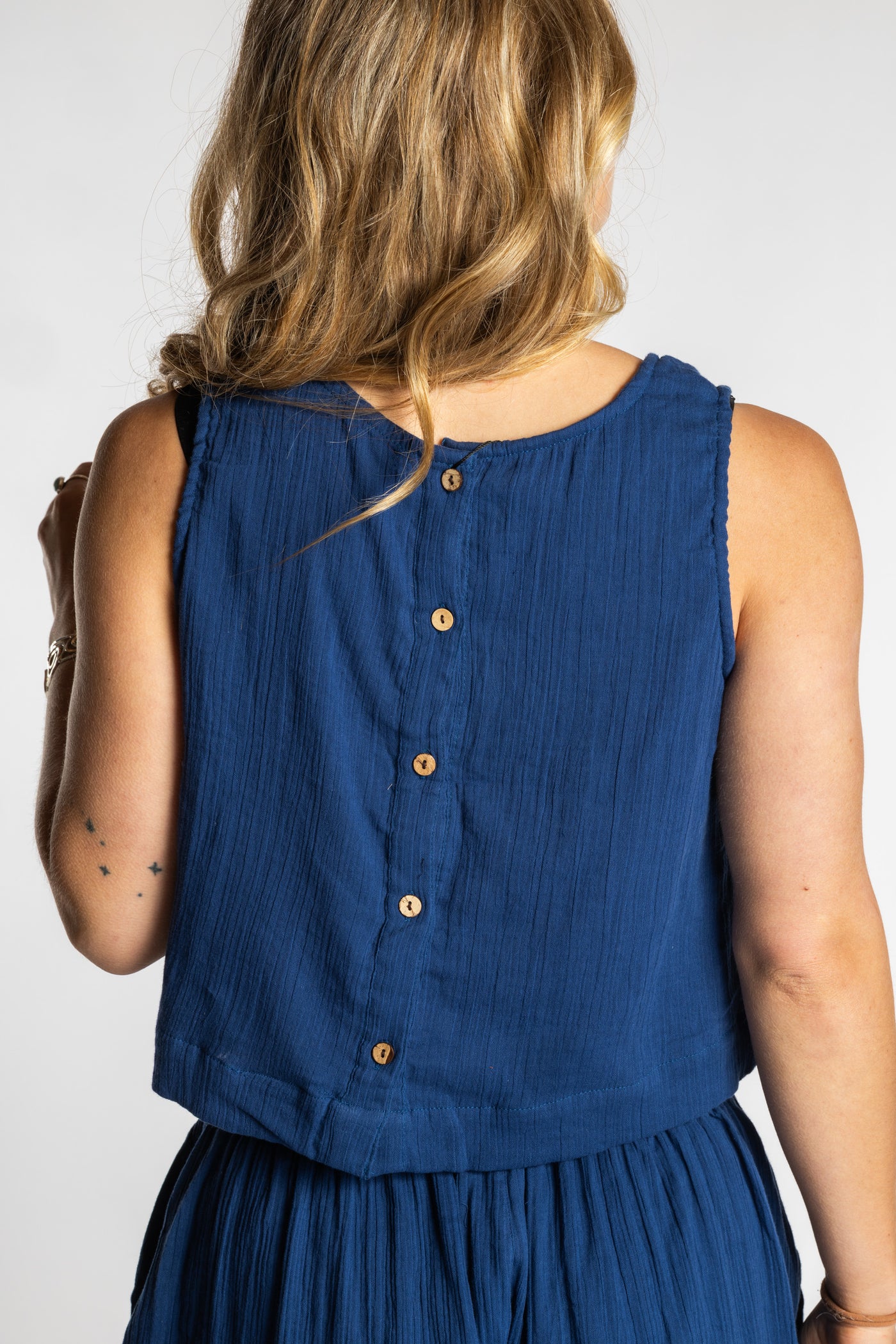 Sophie wearing S/M navy blue sleeveless cotton top with textured fabric and relaxed fit