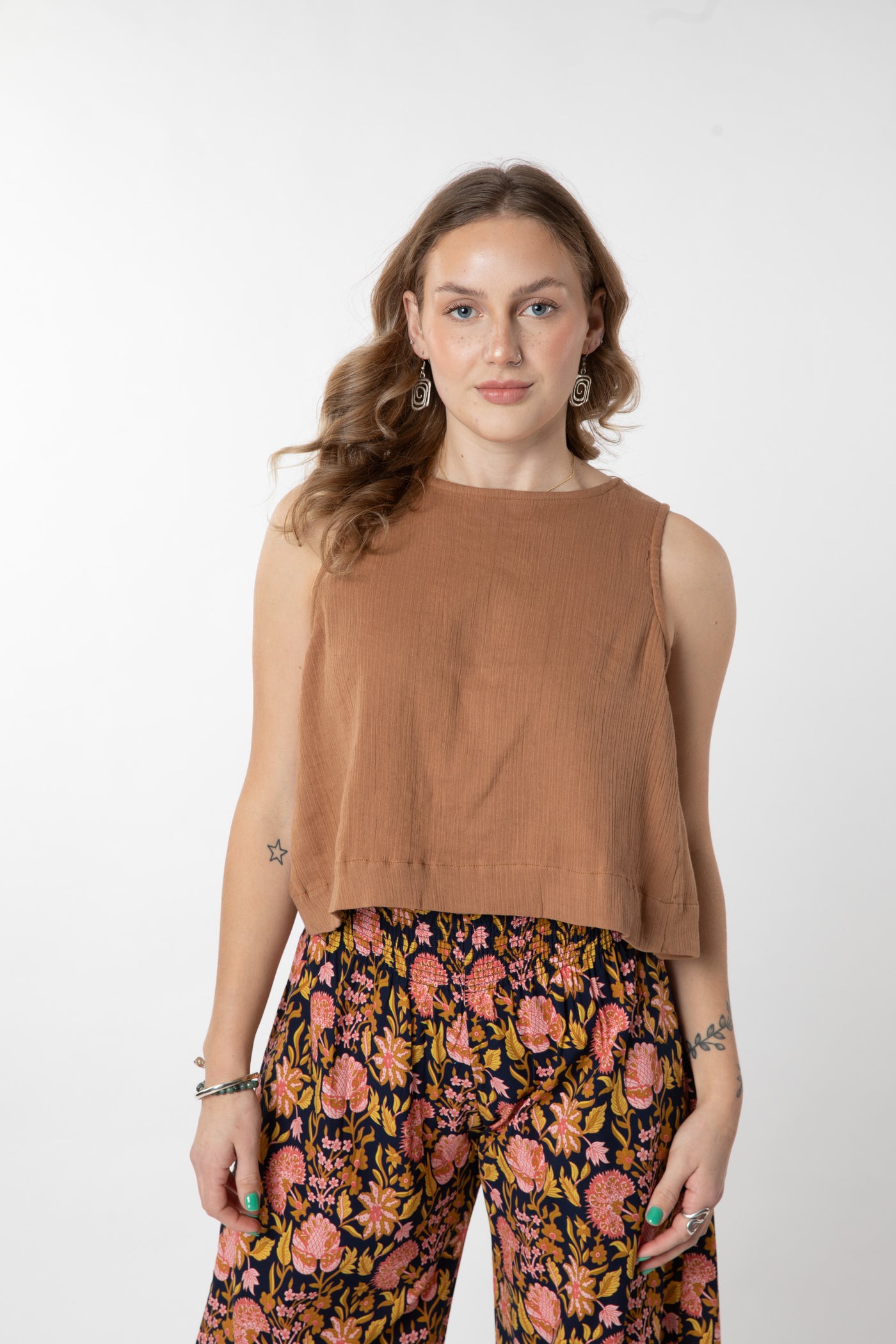 Jacalyn is wearing size S cotton tank top in tan