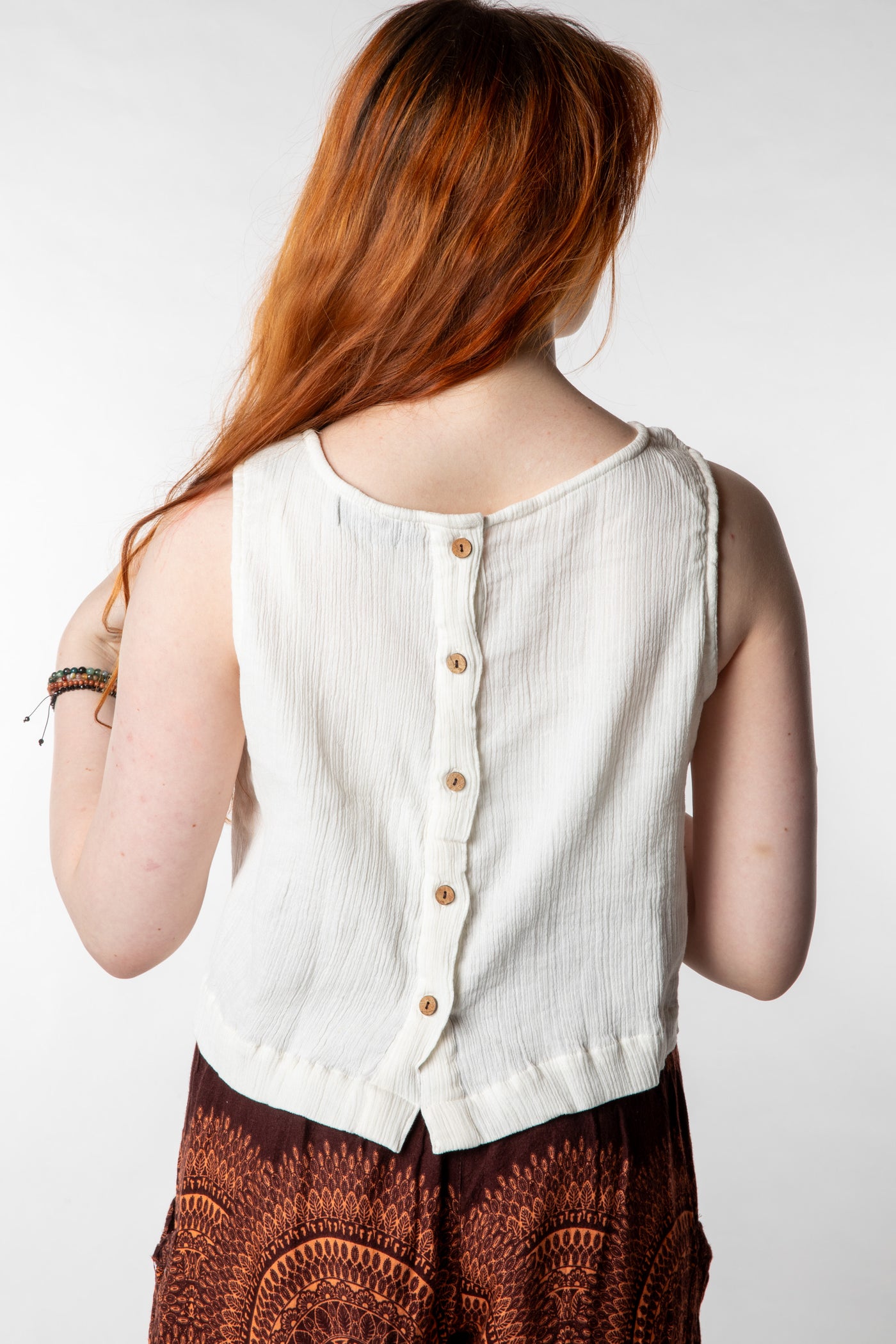 Honora is wearing size S cotton tank top in ivory