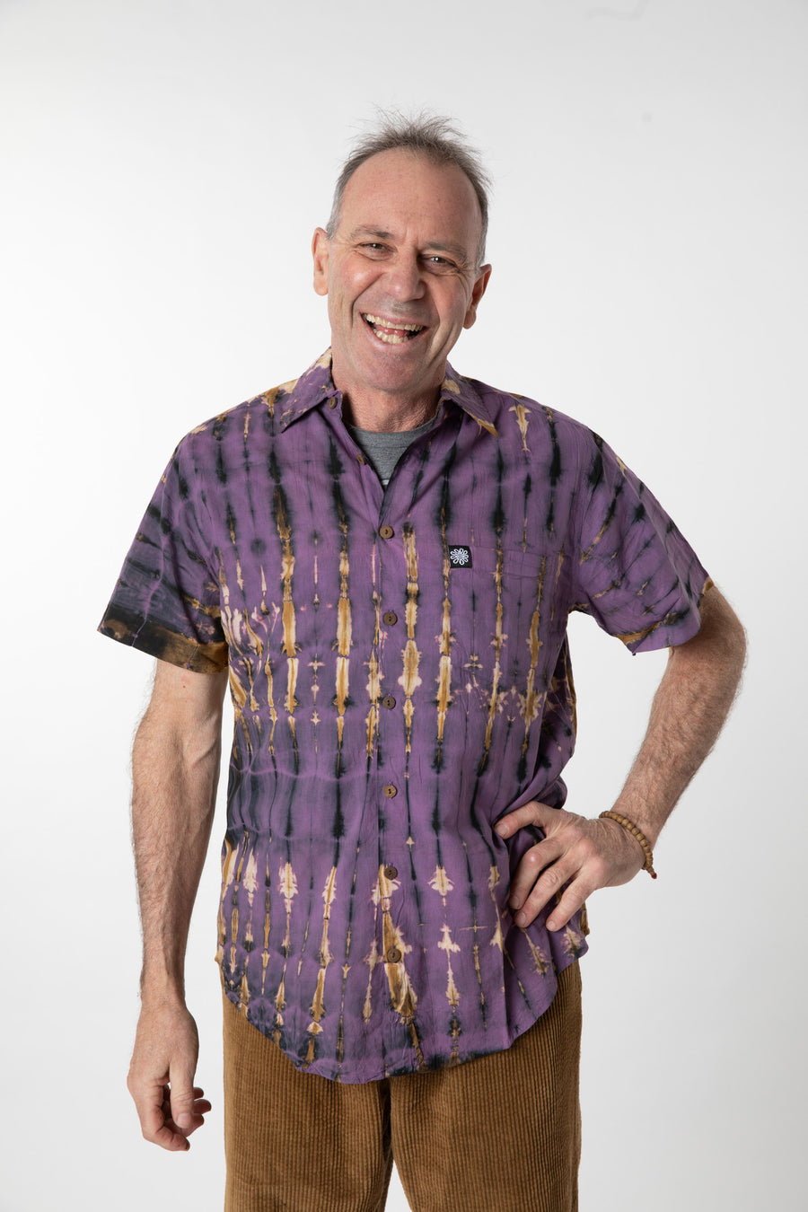Ross is wearing size M cotton tie dye button up shirt in purple