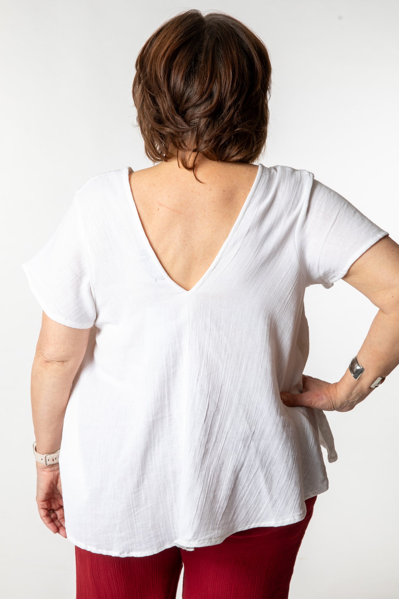 Betty is wearing a cotton top in ivory