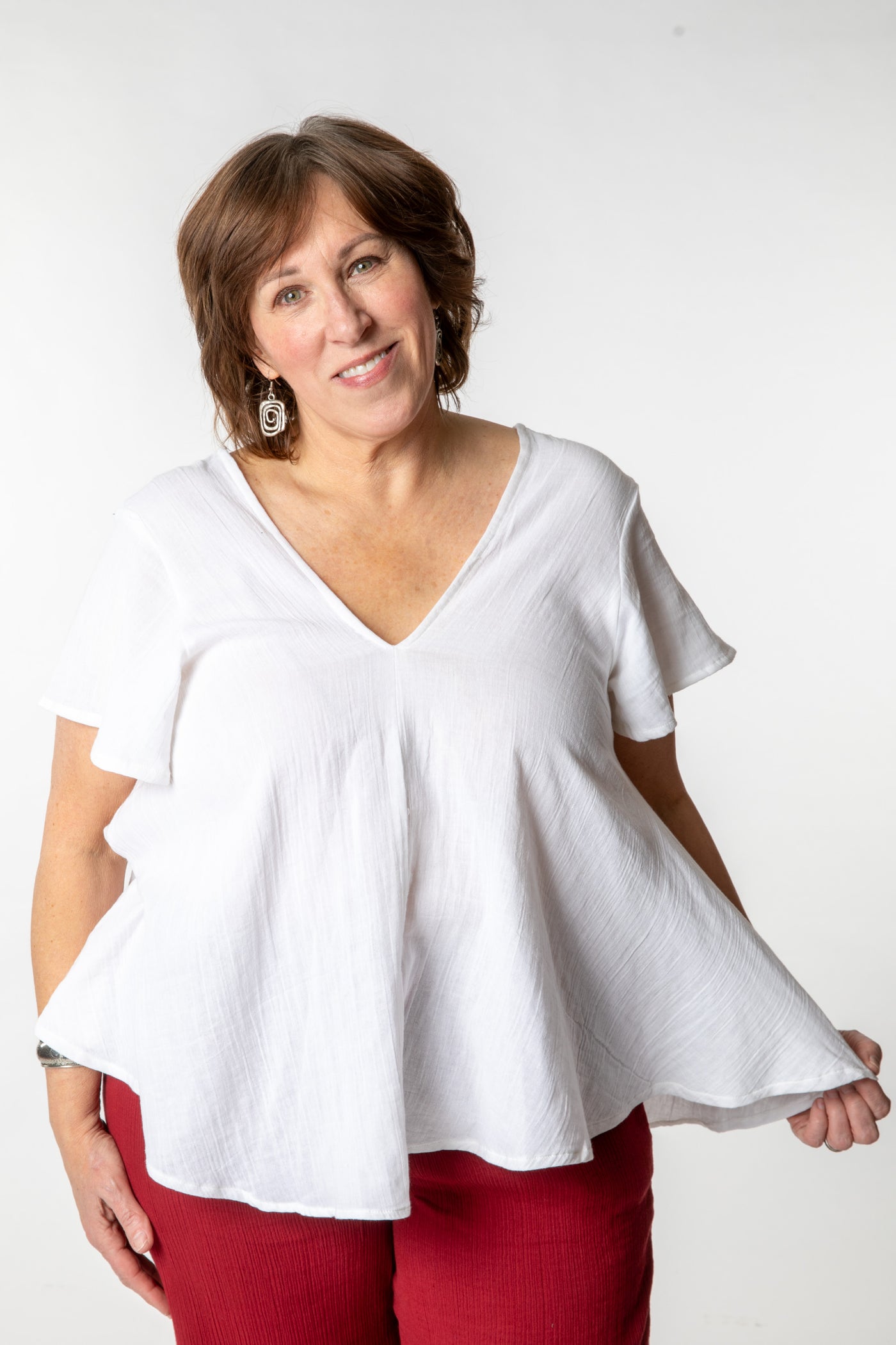 Betty is wearing a cotton top in ivory