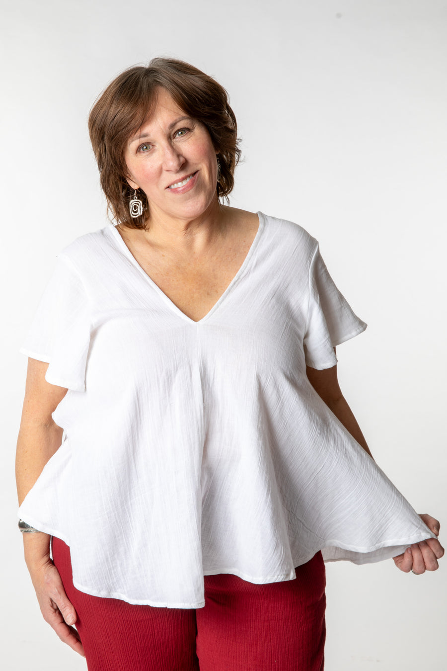 Betty is wearing a cotton top in ivory