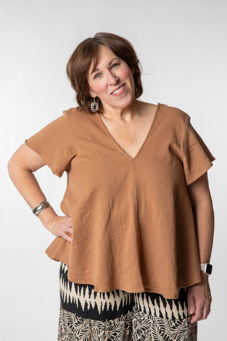 Betty is wearing a cotton top in tan