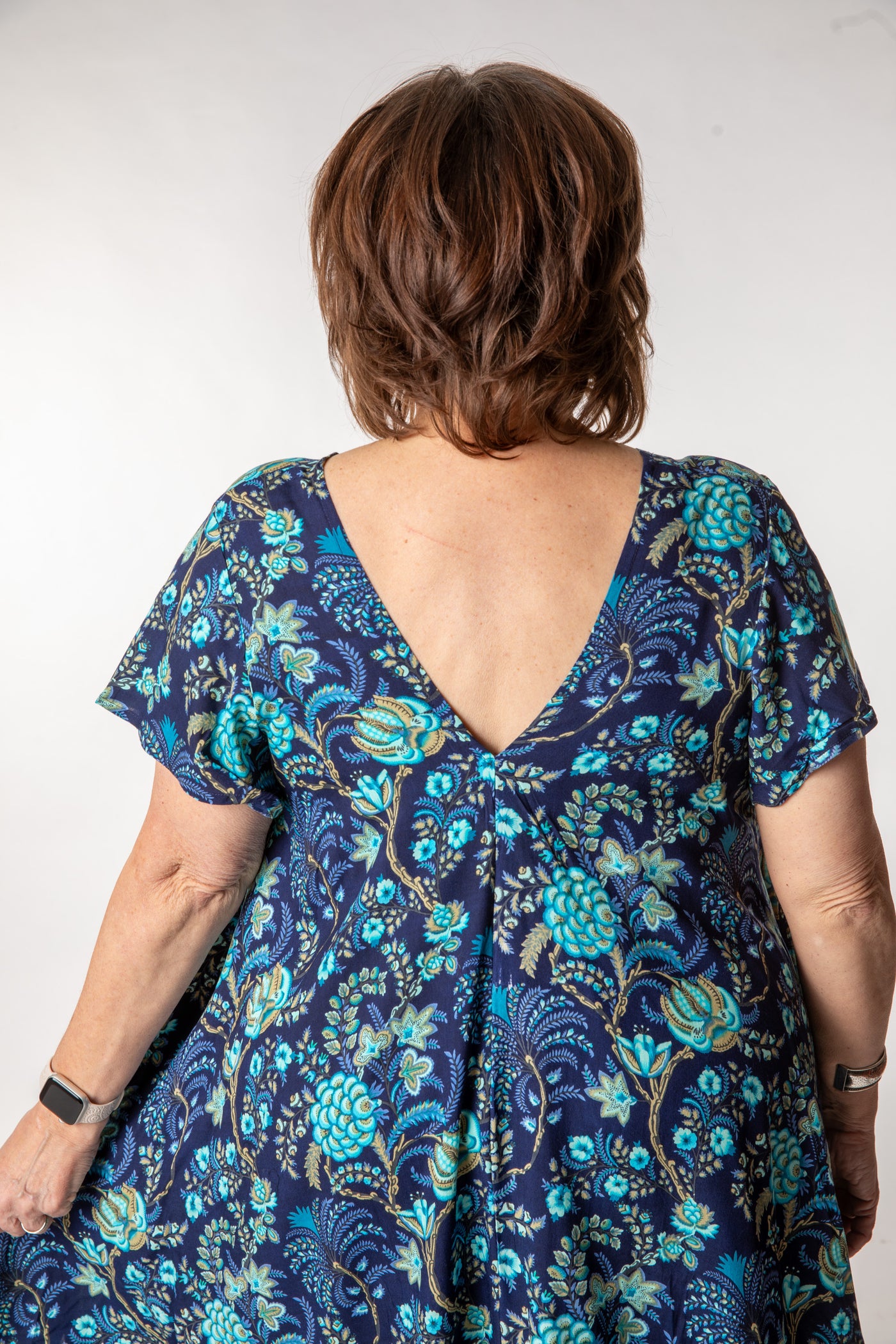 Betty is wearing a babydoll dress in navy blooms