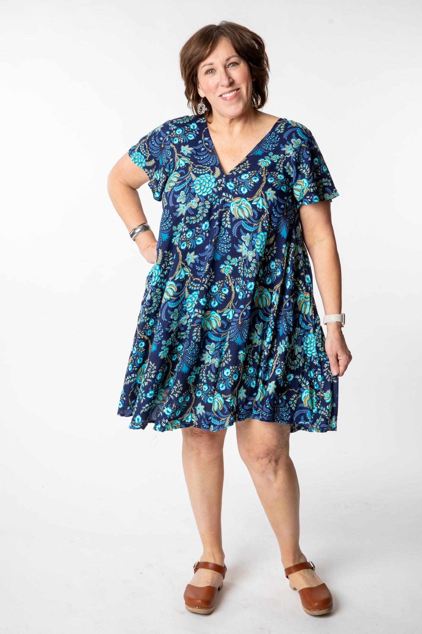 Betty is wearing a babydoll dress in navy blooms