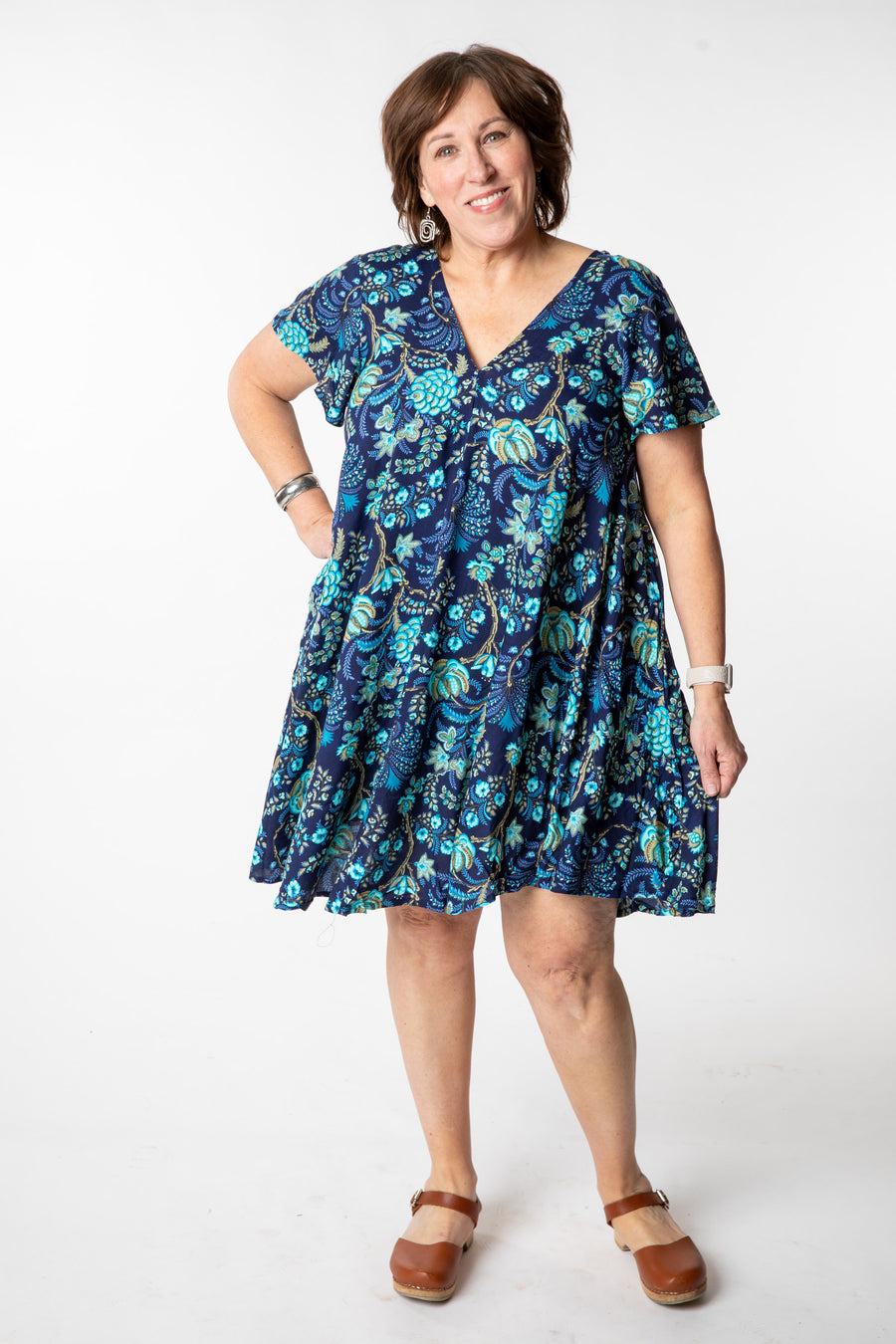 Betty is wearing a babydoll dress in navy blooms