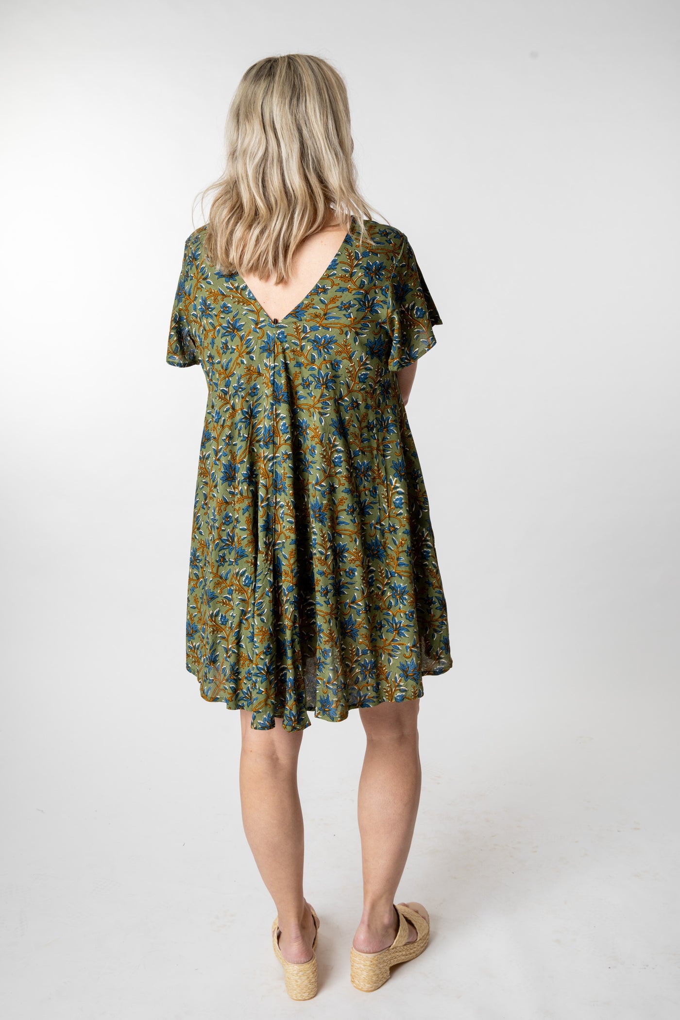 Tish is wearing a babydoll dress in sage floral