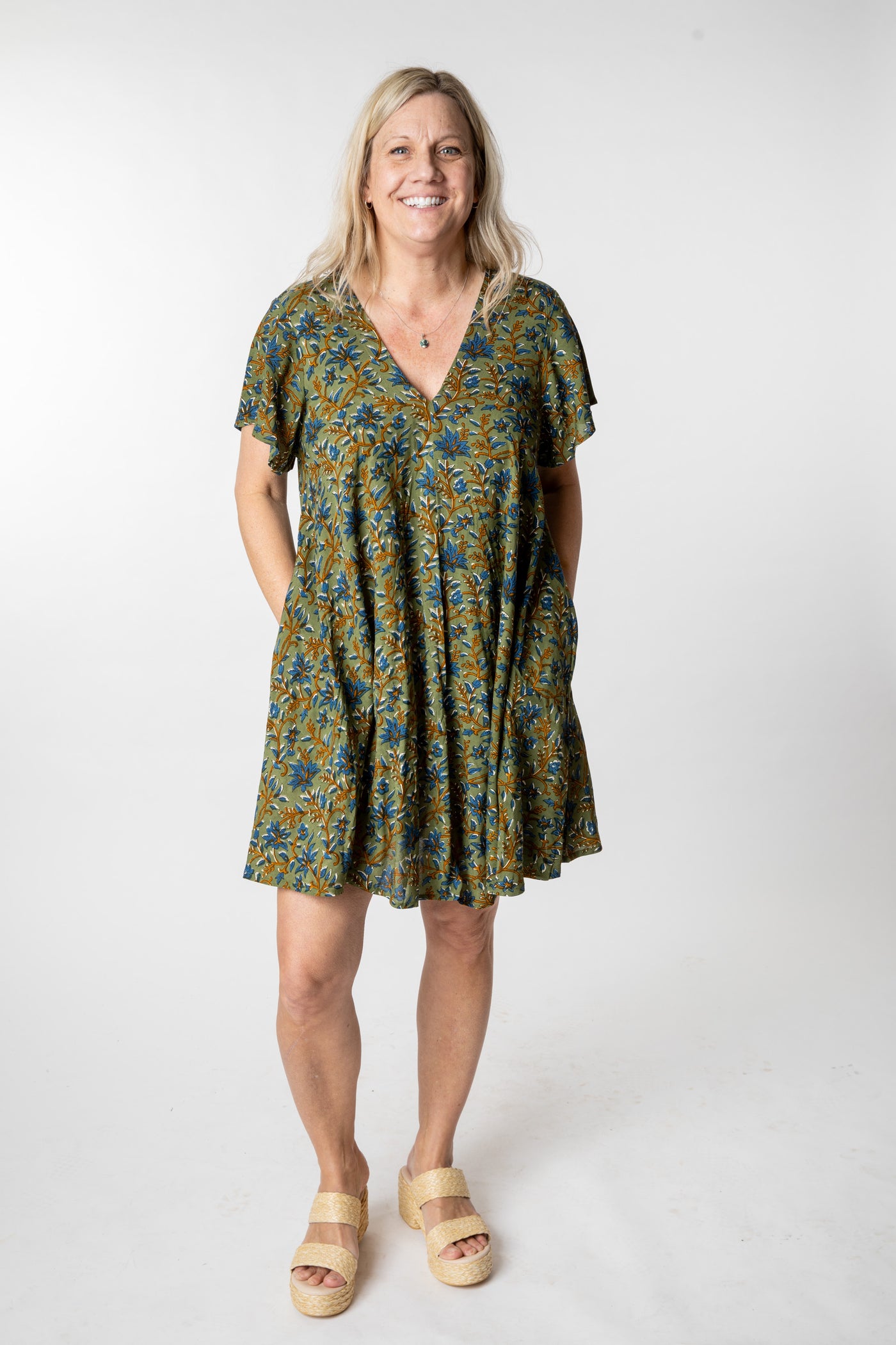 Tish is wearing a babydoll dress in sage floral