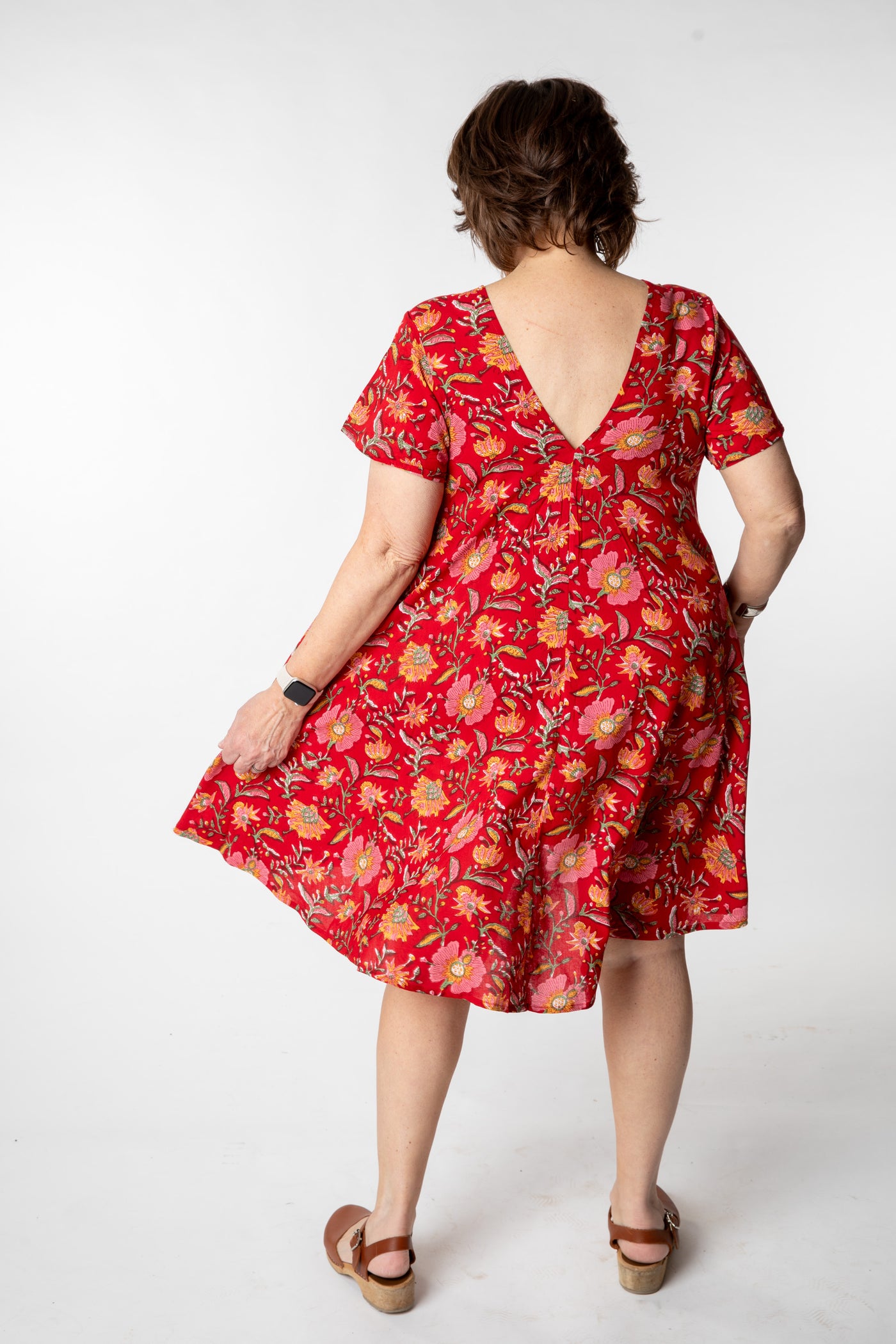 Betty is wearing a babydoll dress in scarlet floral