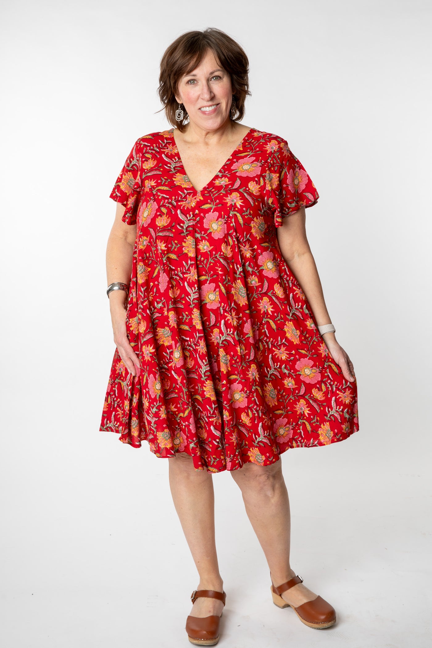 Betty is wearing a babydoll dress in scarlet floral